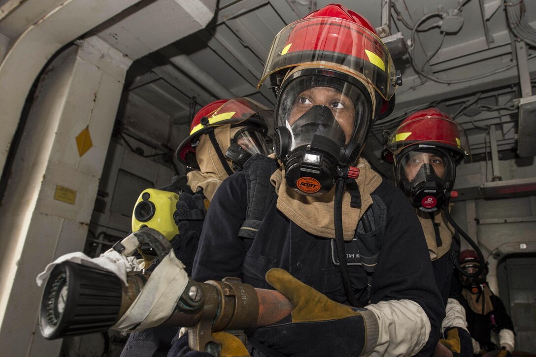 Sailors man a fire hose during a fire drill aboard amphibious assault ship USS Boxer in the Gulf of Aden, May 31, 2016. The Boxer is supporting maritime security operations and theater security cooperation efforts in the U.S. 5th Fleet area of operations. Navy photo by Petty Officer 2nd Class Debra Daco