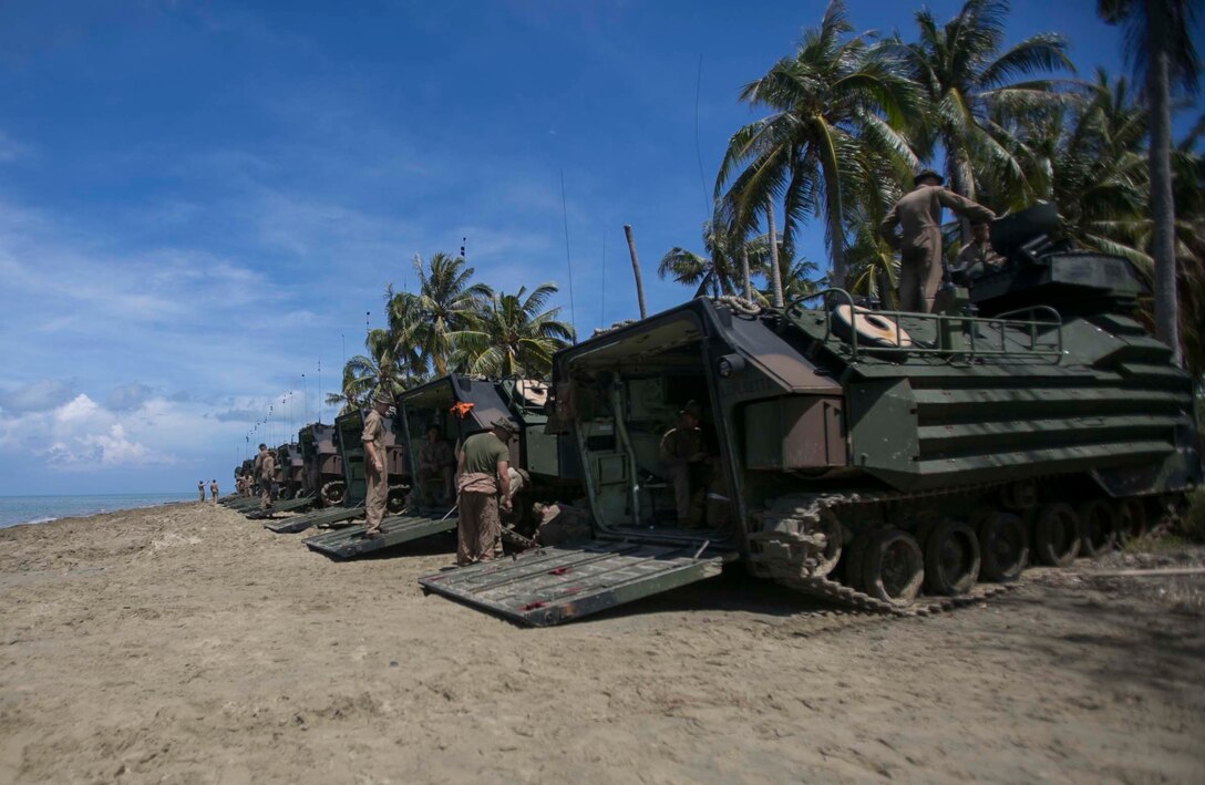 TANDUO BEACH, MALAYSIA (May 30, 2016) – U.S. Marines assigned to Easy Company, Battalion Landing Team, 2nd Battalion, 2nd Marines, let down ramps of Amphibious Assault vehicles after an amphibious transition from ship to shore. The Marines are embarked with U.S. Sailors aboard the USS Ashland (LSD 48) in support of exercise Cooperation Afloat Readiness and Training. CARAT is a series of annual, bilateral maritime exercises between the U.S. Navy, U.S. Marine Corps and the armed forces of nine partner nations to include Bangladesh, Brunei, Cambodia, Indonesia, Malaysia, Singapore, the Philippines, Thailand and Timor-Leste. The Ashland is assigned to U.S. 7th Fleet.  (U.S. Navy photo by Lance Cpl. Carl King Jr/. Released)