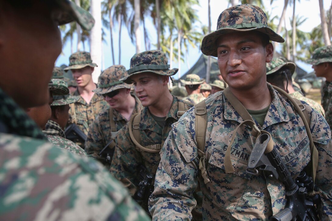 TANDUO BEACH, MALAYSIA (May 30, 2016) – U.S. Marines assigned to Easy Company, 2nd Battalion, 2nd Marines), greet service members of the Royal Malay Army after an amphibious transition from ship to shore. The Marines are embarked with U.S. Sailors aboard the USS Ashland (LSD 48) in support of exercise Cooperation Afloat Readiness and Training. CARAT is a series of annual, bilateral maritime exercises between the U.S. Navy, U.S. Marine Corps and the armed forces of nine partner nations to include Bangladesh, Brunei, Cambodia, Indonesia, Malaysia, Singapore, the Philippines, Thailand and Timor-Leste.The Ashland is assigned to U.S. 7th Fleet. (U.S. Navy photo by Lance Cpl. Carl King Jr/. Released)