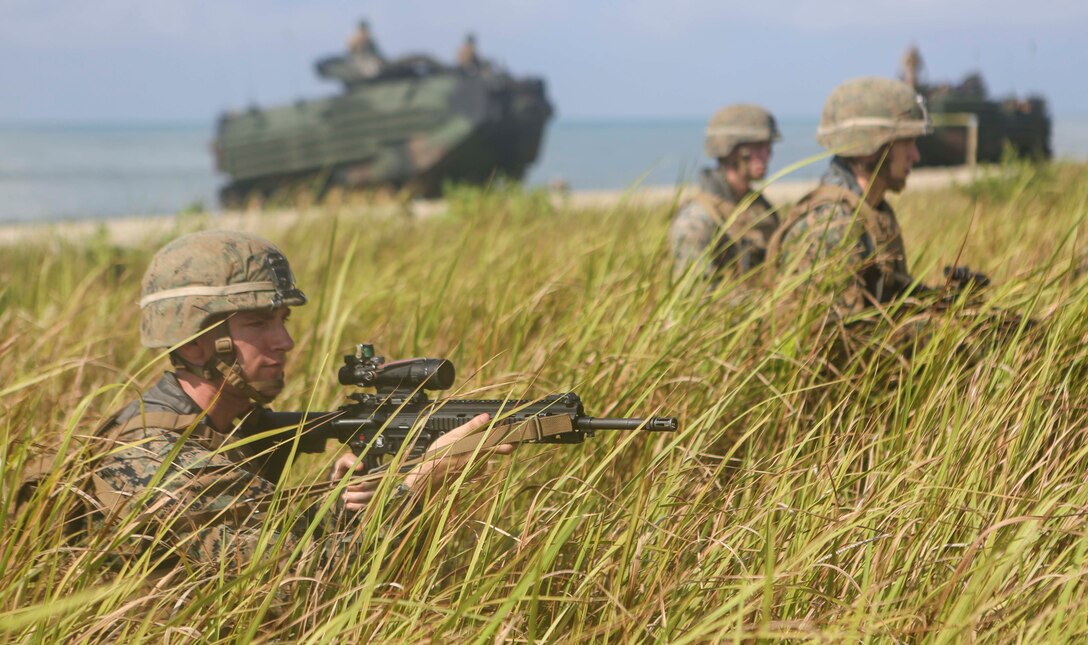 TANDUO BEACH, MALAYSIA (May 30, 2016) – U.S. Marines assigned to Easy Company, Battalion Landing Team, 2nd Battalion, 2nd Marines post security after an amphibious transition from ship to shore. The Marines are embarked aboard the USS Ashland (LSD 48) in support of exercise Cooperation Afloat Readiness and Training. CARAT is a series of annual, bilateral maritime exercises between the U.S. Navy, U.S. Marine Corps and the armed forces of nine partner nations to include Bangladesh, Brunei, Cambodia, Indonesia, Malaysia, Singapore, the Philippines, Thailand and Timor-Leste.The Ashland is assigned to U.S. 7th Fleet. (U.S. Navy photo by Lance Cpl. Carl King Jr/. Released)
