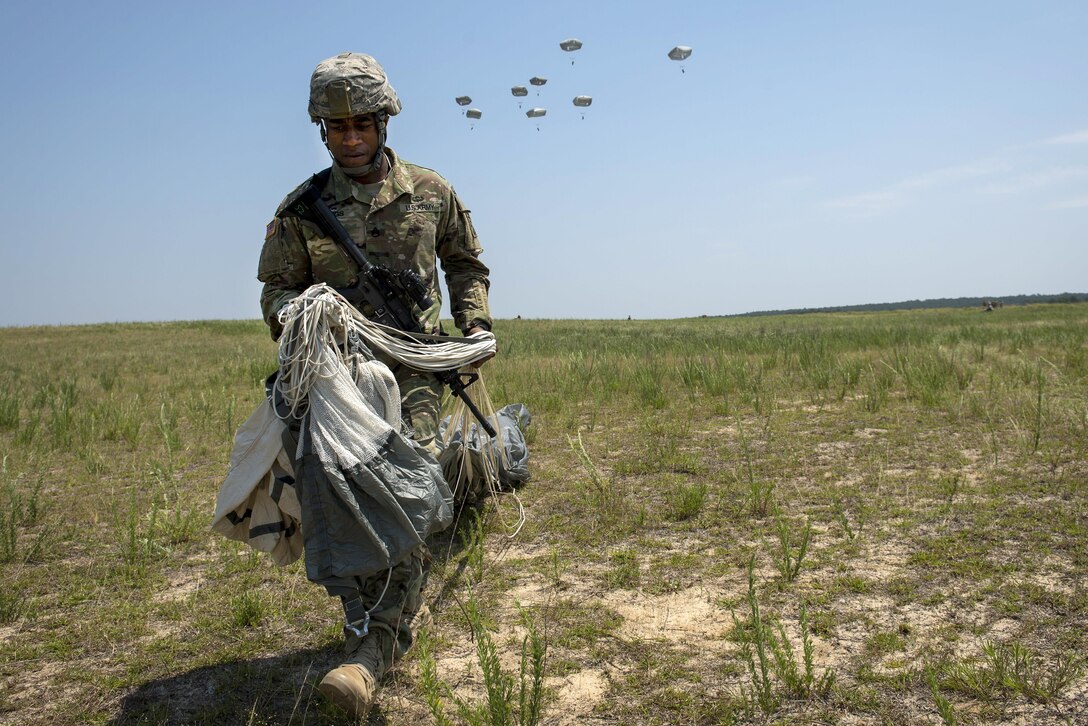 Army Staff Sgt. Dupree Jennings straightens recovers his chute after landing on the drop zone during exercise Crescent Reach at Fort Bragg, N.C., May 26, 2016. Jennings is assigned to the 82nd Airborne Division’s 2nd Battalion, 508th Parachute Infantry Regiment, 2nd Brigade Combat Team. Air Force photo by Airman 1st Class Sean Carnes