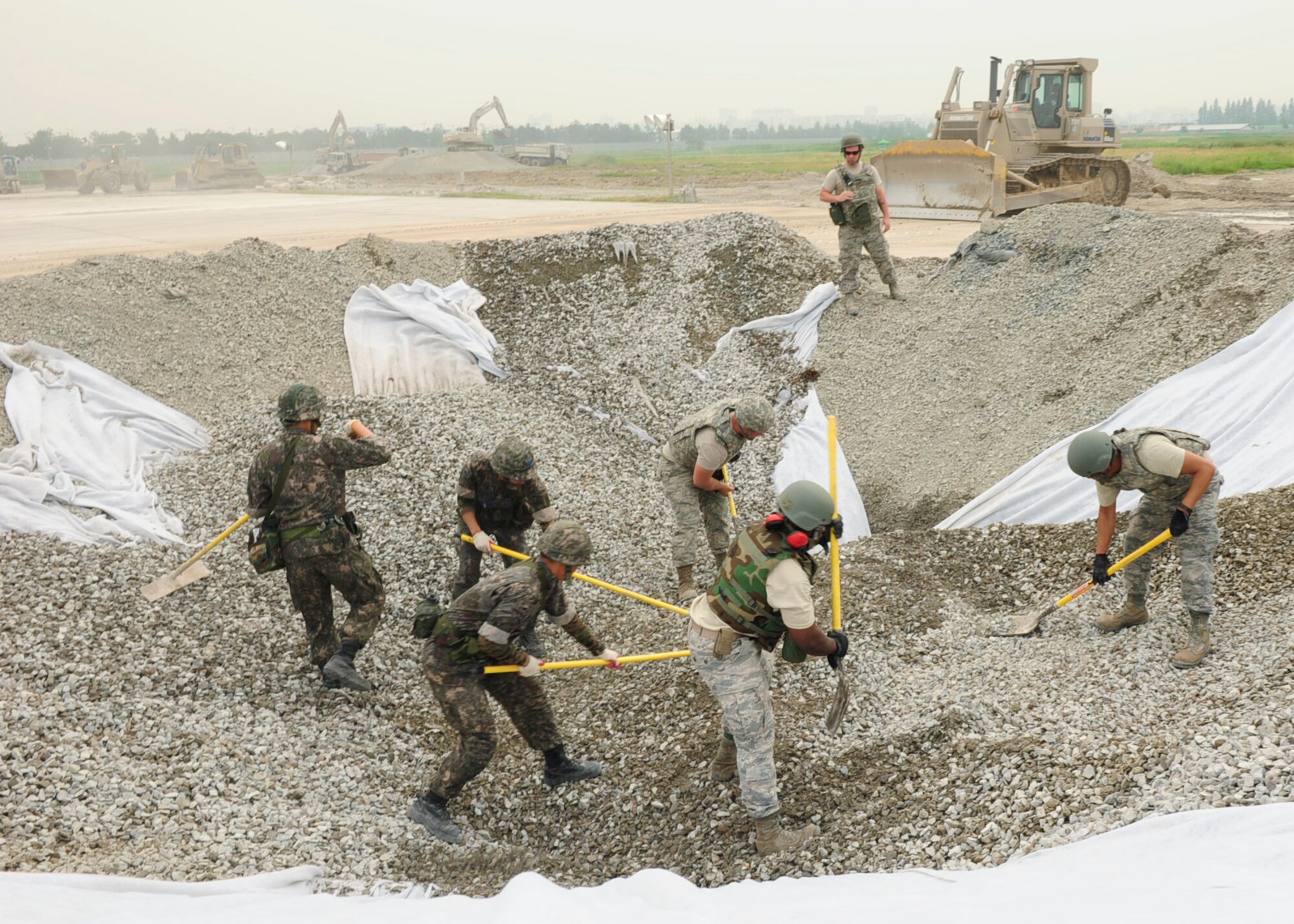 Airmen assigned to Pacific Air Forces bases excavate and refill a crater on the airfield at Gwangju Air Base during an Airfield Damage Repair bilateral training scenario on June 1, 2016. The training is part of Pacific Unity, a bilateral training exercise designed to enhance interoperability and build partnership capacity in the Indo-Asia Pacific region. (U.S. Air Force photo/Staff Sgt. Chelsea Browning)