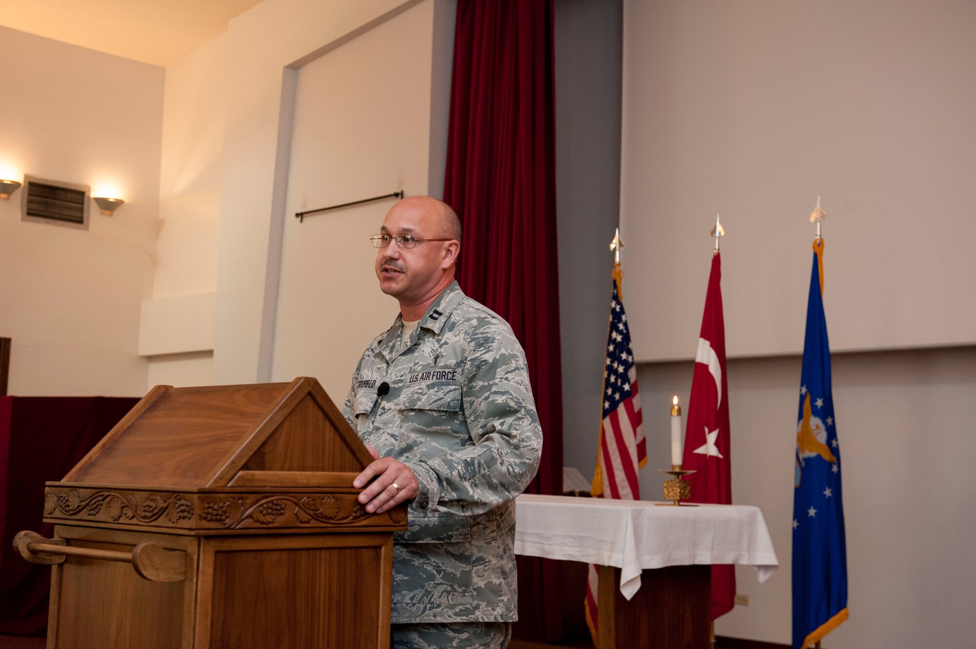 U.S. Air Force Chaplain (Capt.) David Merrifield, 39th Air Base Wing, speaks to the audience at a Memorial Day remembrance ceremony held at the base chapel May 27, 2016, at Incirlik Air Base, Turkey. Merrifield spoke on remembering we stand on the shoulders of those who came before us and paid the ultimate price. (U.S. Air Force photo by Staff Sgt. Jack Sanders/Released)