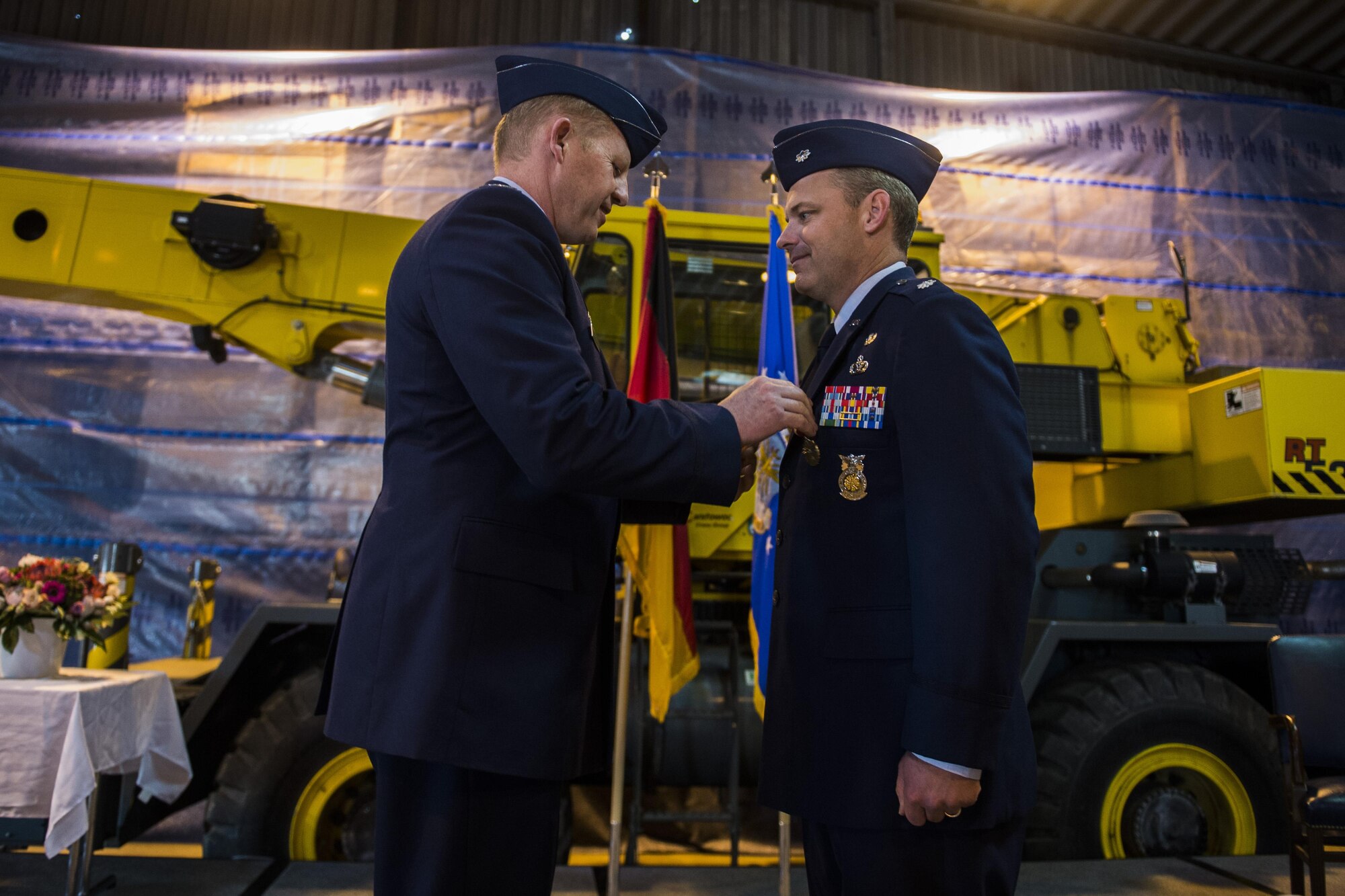 U.S. Air Force Col. Joe McFall, 52nd Fighter Wing commander, left, pins a Meritorious Service Medal on U.S. Air Force Lt. Col. Christopher Meeker, former 52nd Civil Engineer Squadron commander, during the 52nd CES change of command at Spangdahlem Air Base, Germany, June 1, 2016. The Meritorious Service Medal is awarded to members of the Armed Forces of the United States and friendly foreign nations who distinguished themselves by outstanding noncombat meritorious achievement. (U.S. Air Force photo by Senior Airman Luke Kitterman/Released)