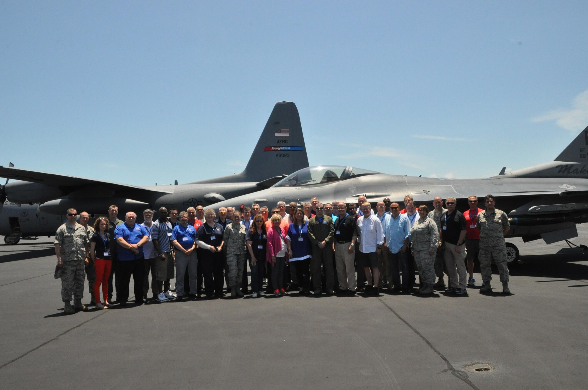 A group of 35 civic leaders and their military escorts, all participants in the 910th Airlift Wing’s 2016 Civic Leader Tour, originating from Youngstown Air Reserve Station, Ohio, stand in front of an F-16 Fighting Falcon aircraft, assigned to the 482nd Fighter Wing and one of the 910th’s C-130 Hercules aircraft on the flightline here, April 29, 2016. A walk around of the F-16 was part of the itinerary of the two-day event, held April 28-29, 2016, designed to give attendees a better understanding of Air Force Reserve and Joint Operation missions and how they differs from base to base around the country. (U.S. Air Force photo/Master Sgt. Bob Barko Jr.)