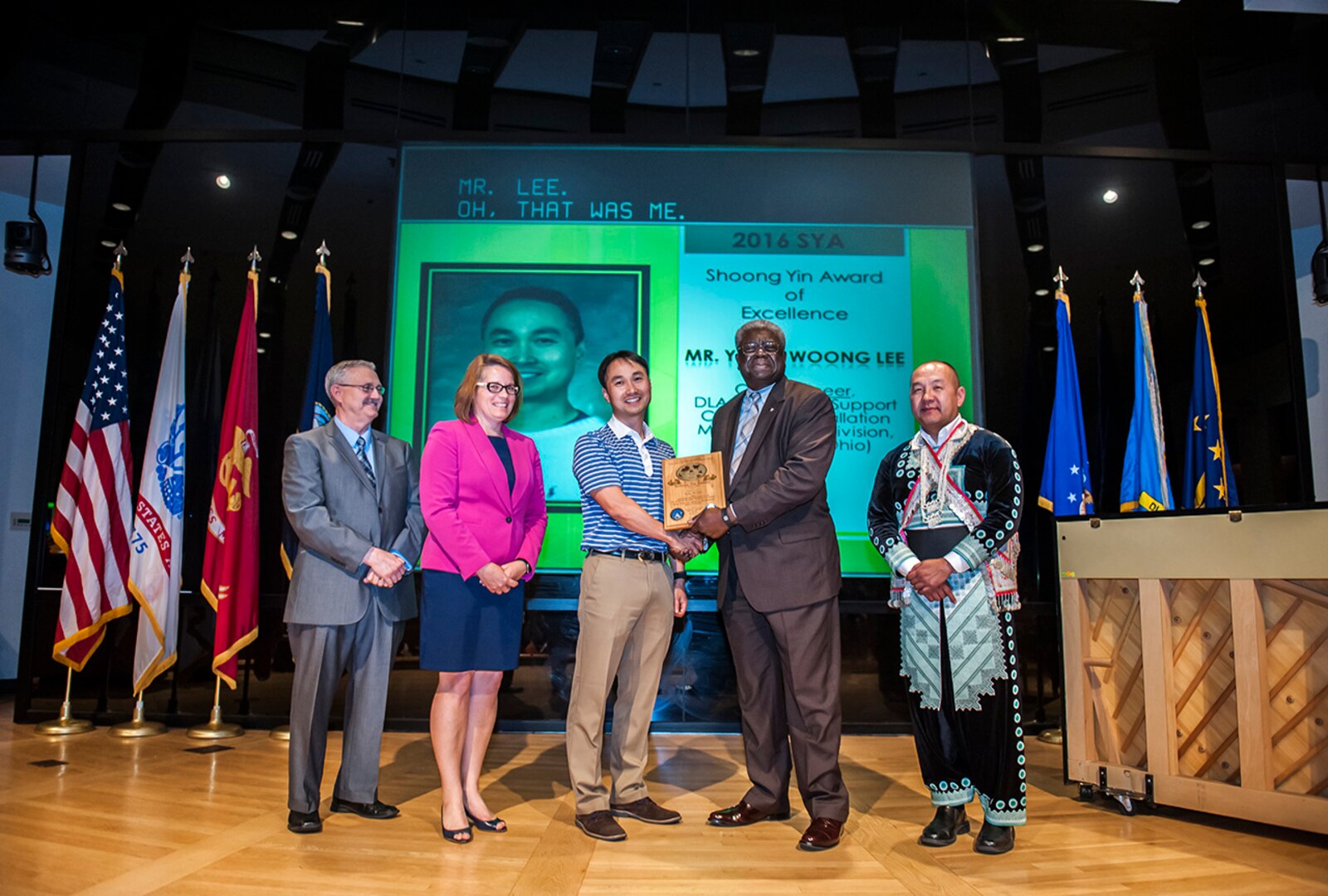 Yong Woong Lee (middle), a civil engineer with DLA Installation Support-Columbus, received the 2016 Shoong Yin Award for his dedication and commitment to the AAPI community. Pictured (l-r) is: Paul Gambrell, DLA Land and Maritime Equal Employment Office; Rebecca Beck, DFAS-Columbus deputy director; Lee; Milton Lewis, DLA Land and Maritime acquisition executive; and Yee Hang, Land Supplier director.  