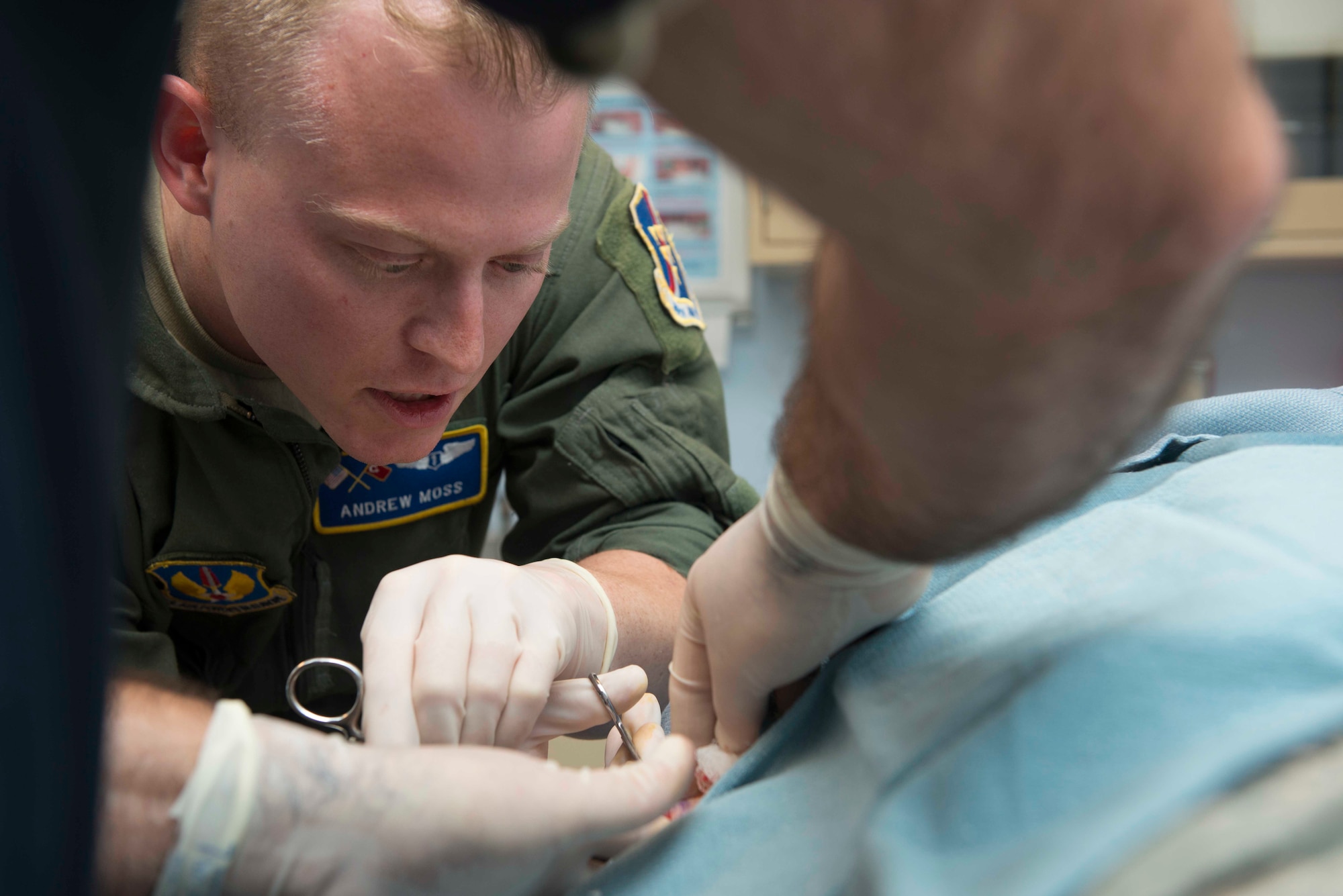 U.S. Air Force Capt. Andrew Moss, 39th Medical Operations Squadron flight surgeon, performs a cyst removal May 19, 2016, at Incirlik Air Base, Turkey. Flight surgeons are primary care physicians for aircrew members. (U.S. Air Force photo by Senior Airman John Nieves Camacho/Released)