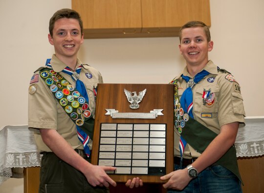 Daniel O’Connor, left, and Matthew O’Connor, both Boy Scouts of America Troop 165 Eagle Scouts, hold up the Eagle Scout recognition board during a ceremony in the base chapel at Spangdahlem Air Base, Germany, May 18, 2016. BSA Troop 165 added Daniel and Matthew O’Connors to a plaque listing the names of those who earned the top rank from their troop. (U.S. Air Force photo by Airman 1st Class Timothy Kim/Released)