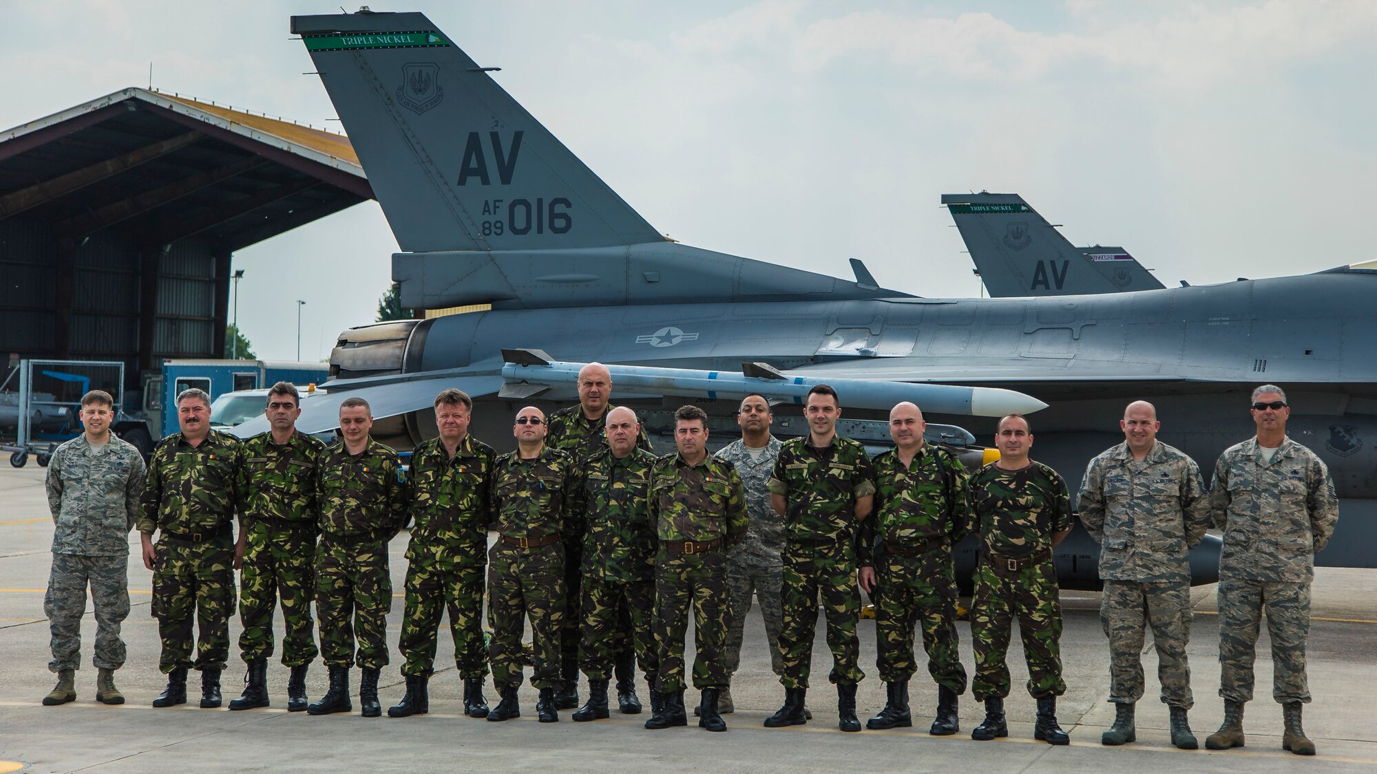 31st Maintenance Squadron Airmen post with a delegation of Romanian air force officers and airmen, May 24, 2016, at Aviano Air Base, Italy. The Romanians visited here to expand their expertise in and understanding of F-16 Fighting Falcon repairs and logistical support. (Courtesy photo)