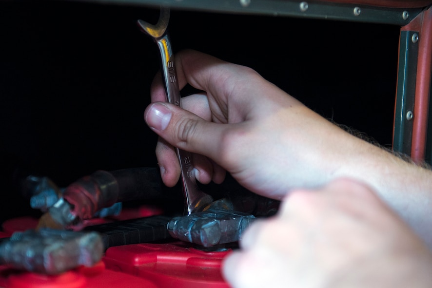 A U.S. Air Force Airman from the 23d Equipment Maintenance Squadron’s aerospace ground equipment flight tightens a battery terminal on a large aircraft starting system, June 1, 2016, at Moody Air Force Base, Ga. The AGE flight performs scheduled and unscheduled maintenance jobs such as diagnosing mechanical and electronic circuitry malfunctions, as well as inspecting and approving completed maintenance actions. (U.S. Air Force photo by Airman 1st Class Greg Nash/Released)