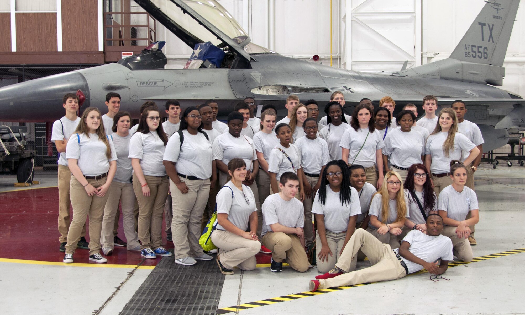 Lakeview High School Air Force Junior ROTC cadets pose in front of an F-16 Fighting Falcon at the end of their base tour at Naval Air Station Fort Worth Joint Reserve Base, Texas, May 24. Cadets toured the base air traffic control tower, the 301st Aircrew Flight Equipment and Maintenance Group, as well as experienced eating at Moreland Dining Hall. (U.S. Air Force photo by Staff Sgt. Melissa Harvey)