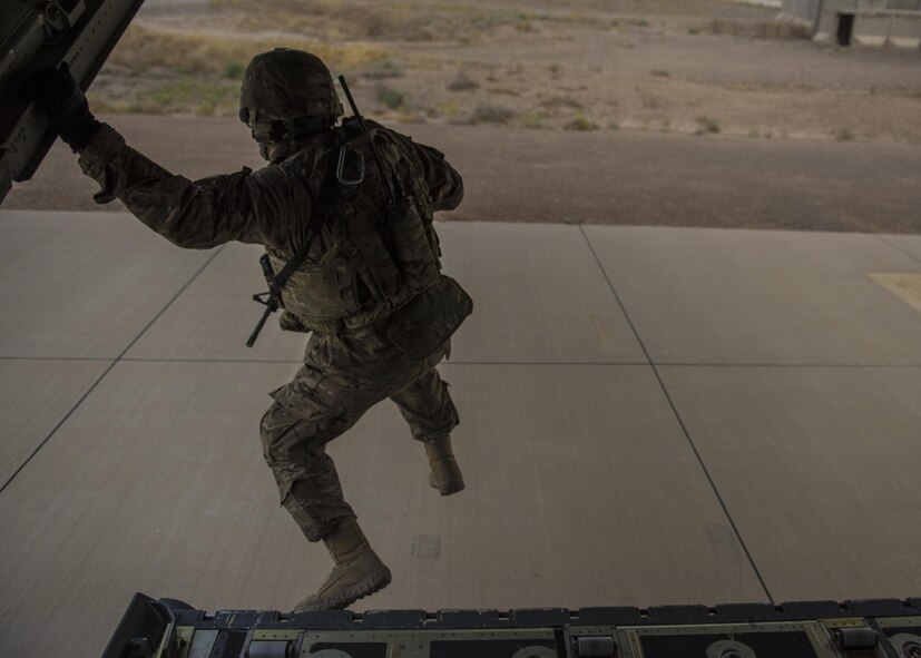 Staff Sgt. Jesus Mora, 455th Expeditionary Security Forces Squadron fly away security team lead, jumps from the ramp of a C-130J Super Hercules to provide security while it executes a combat cargo drop, Multinational Base Tarin Kowt, Afghanistan, June 1, 2016. The FAST team provided support to the 774th Expeditionary Airlift Squadron as they executed a combat load drop. (U.S. Air Force photo by Senior Airman Justyn M. Freeman)