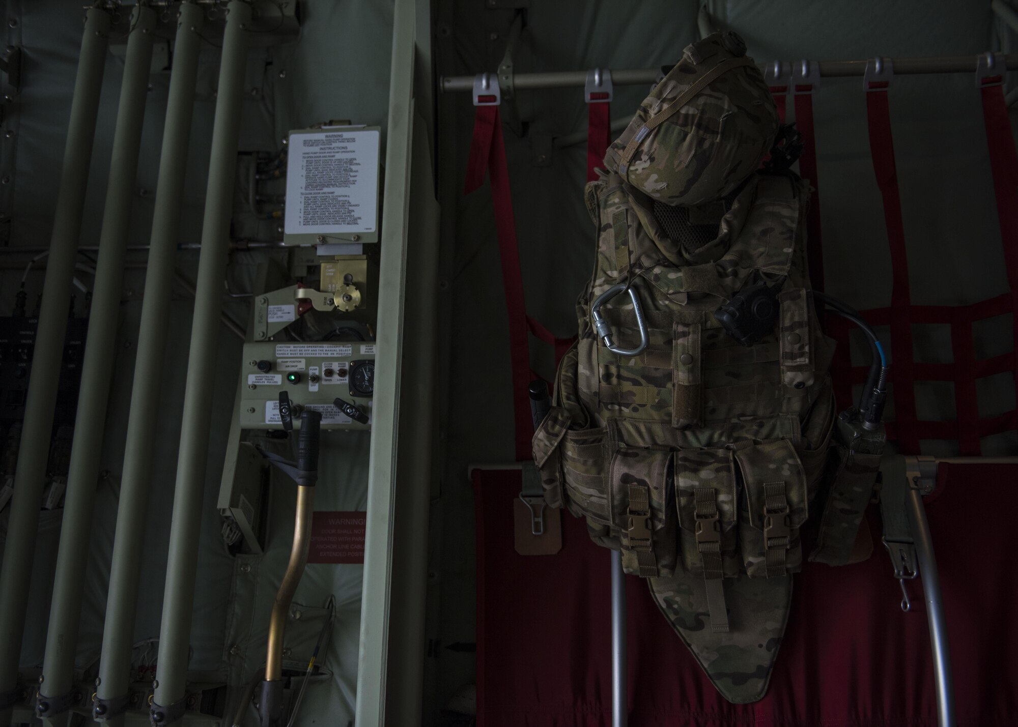 Senior Airman Tyler Clausen, fly away security team member from the 455th Expeditionary Security Forces Squadron, hangs his gear on a C-130J Super Hercules before it executes a combat cargo drop, Multinational Base Tarin Kowt, Afghanistan, June 1, 2016. The FAST team provided support to the 774th Expeditionary Airlift Squadron as they executed a combat load drop. (U.S. Air Force photo by Senior Airman Justyn M. Freeman)
