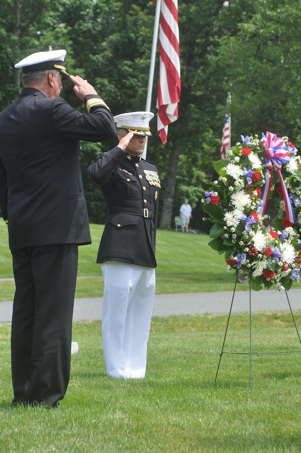 Col. Joseph Murray, commander, MCINCR-MCB Quantico, renders honors to the fallen on Memorial Day at Quantico National Cemetery. Above right: Veterans, dressed in Colonial-era uniforms, present the colors at Memorial Day ceremonies.