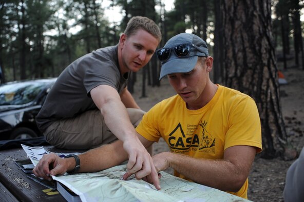 U.S. Air Force Senior Airman Michael and Senior Airman John, USAF 50 Summits Challenge participants, look over a map at Fort Tuthill County Park Ariz., May 28, 2016. The group of participants consisting of U.S. Airmen, veterans and civilians camped out the night before summiting Humphreys Peak, the highest point in Arizona. (U.S. Air Force photo by Airman 1st Class Ashley N. Steffen/Released)
