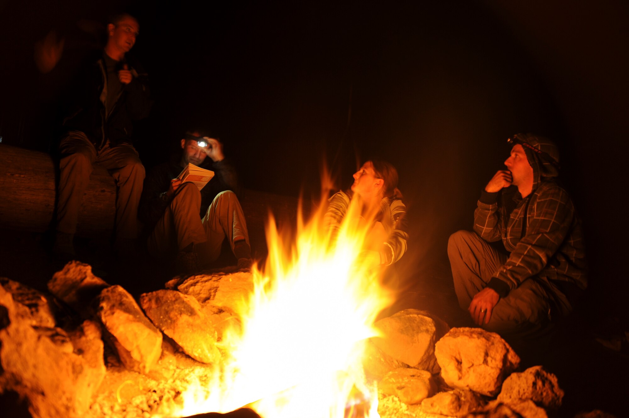Participants of the U.S. Air Force 50 Summits Challenge converse around a fire at Fort Tuthill County Park Ariz., May 28, 2016. The group of participants consisting of U.S. Airmen, veterans and civilians camped out the night before summiting Humphreys Peak, the highest point in Arizona. (U.S. Air Force photo by Airman 1st Class Ashley N. Steffen/Released)