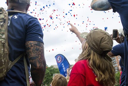 A child points to her balloon, which she released with a note to her dad who passed away while in support of the military, during the Tragedy Assistance Program for Survivors (TAPS) National Military Survivors Seminar and Good Grief Camp in Crystal City, Va., on May 29.  TAPS is an organization that provides support to people who are affected by the death of a military service member. (U.S. Army photo by Spc. Victoria Friend)