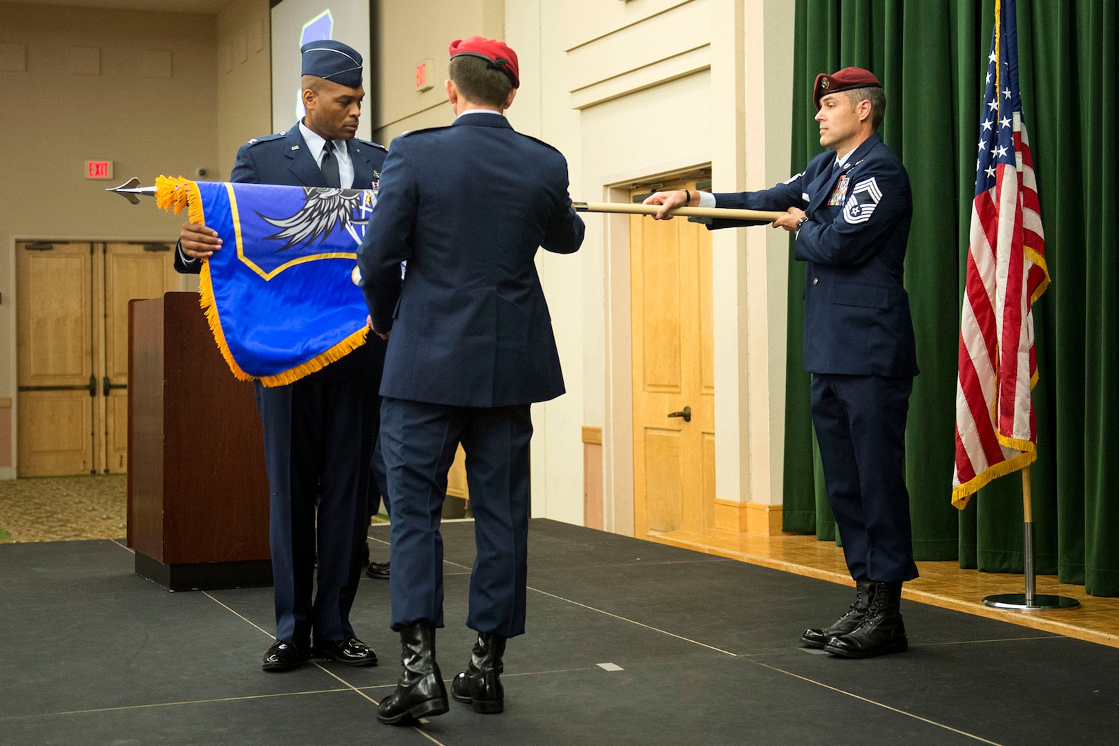 Chief Master Sgt. Ronald Thompson, at right, chief enlisted advisor for the Battlefield Airman Training Group, unfurls the BA TG guidon for Col. Ronald Stenger, incoming commander of the BA TG, left, and Col. Roy Collins, commander of the 37th Training Wing, right, during the group’s activation ceremony June 2, 2016, at Joint Base San Antonio-Lackland, Texas. As a result, BA training, which is currently located across eight locations in seven states, will streamline the training pipeline to reduce costs, and lead to improvements and synergies in the process.