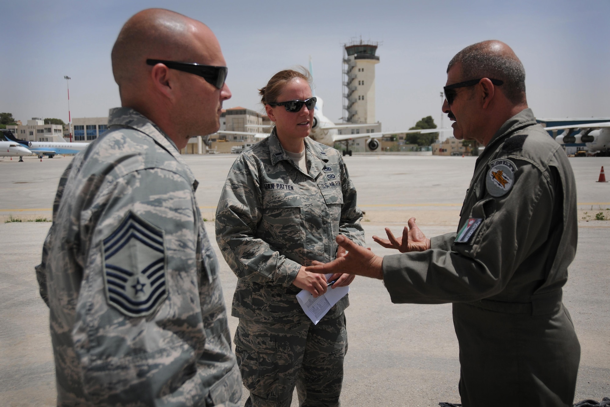 Chief Master Sgt. Marvin Jones, 94th Maintenance Group superintendent, and 1st. Lt. Elizabeth Van Patten, 94th Aircraft Maintenance Squadron officer, discuss C-130 maintenance topics with an Royal Jordanian Air Force C-130 maintenance squadron technician while supporting Exercise Eager Lion, May 15, 2016. This year Eager Lion was a bilaterial exercise including U.S. and Jordanian military forces, held May 15-24. (U.S. Air Force photo/Staff Sgt. Alan Abernethy)
