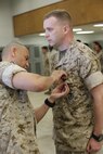 NAVAL SUPPORT FACILITY INDIAN HEAD, MD -- Warrant Officer Daniel Pare, an explosive ordnance disposal officer, with Chemical Biological Incident Response Force (CBIRF), receives the Bronze Star Medal with Combat Distinguishing Device for heroic service in connection with combat operations against the enemy in support of Operation Enduring Freedom while serving as an explosive ordnance disposal team lead, 2nd Marine Logistics Group (Forward), II Marine Expeditionary Force (Forward), in Watan Kalay, Gereshk Valley, Afghan., from Apr. 9, 2011 to Oct. 24, 2011.

Pare, a native of Bristol, Mass., disposed of more than 47,000 pounds of explosive material including 30 improvised explosive devices and 11 enemy weapons caches during this time period.

On July 15, 2011, he rendered aid to a seriously wounded soldier while under heavy enemy fire, and after leaving his covered position, he maneuvered to the wounded soldier and administered critical medical aid until the wounded soldier was evacuated.

While further assisting in the defense of his unit’s position, Pare located a spotter for enemy mortars and directly engaged him with a M2CG recoilless rifle system, ultimately succeeding in neutralizing the enemy observer and decimating the enemy’s will to persist. (Official USMC Photos by Sgt. Santiago G. Colon Jr./Released) 
