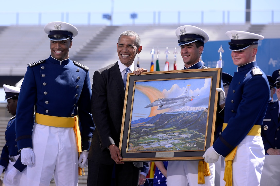 Air Force cadets Kristov George, Daniel Alotta and Mark Caldwell Jr.  present a gift to President Barack Obama from the Class of 2016 during the commencement ceremony at the U.S. Air Force Academy in Colorado Springs, Colo., June 2, 2016. Air Force photo by Bill Evans