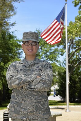Airman 1st Class Jae Yen Kim, 33rd Fighter Wing resource advisor, stands with the American flag at Eglin Air Force Base, Fla., May 4th, 2016. Kim recently received his United States citizenship after complications caused a nine month delay. With his citizenship secured, the budget specialist plans to apply to officer training school to commission as a cost analysis officer. (U.S. Air Force Photo/Senior Airman Andrea Posey)