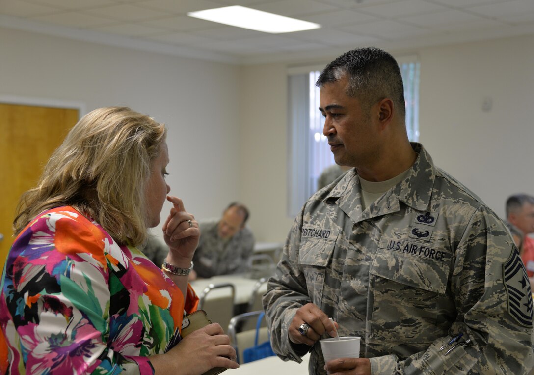 Brook DeWolf, wife of Col. Greg DeWolf, 82nd Medical Group commander, and Chief Master Sgt. Joseph Pritchard, 82nd Training Wing command chief, converse at the Key Spouse Dinner at Sheppard Air Force Base, Texas, May 24, 2016. Wing leadership focused on bringing the Key Spouses together to fellowship, highlight the Key Spouses' success and to open up to leadership about challenges they face as a part of the program. (U.S. Air Force photo/2nd Lt. Brittany Curry)