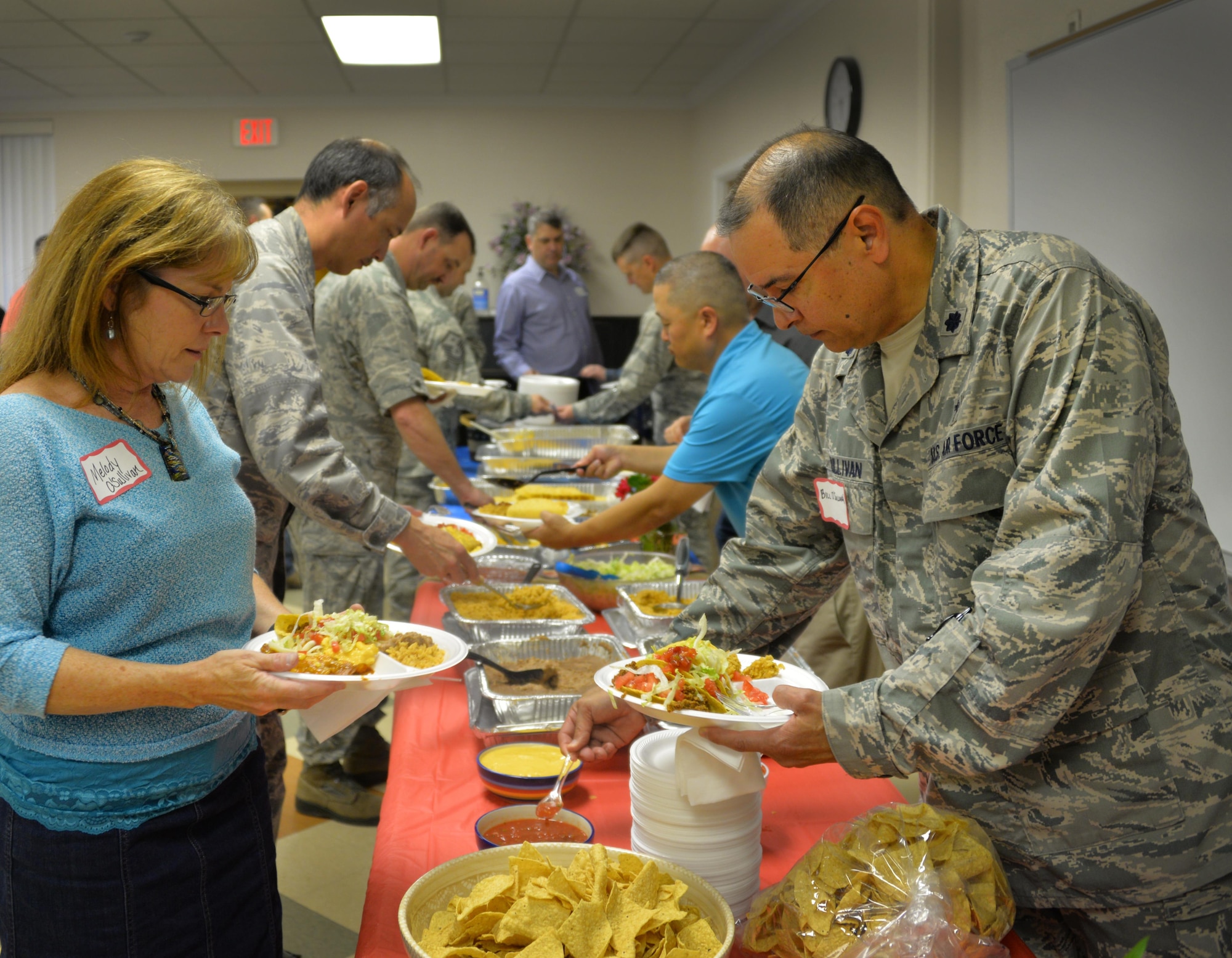Melody O'Sullivan and Chaplain (Lt. Col.) William O'Sullivan, 82nd Training Wing chaplain, plate their food, provided by Mike Winslow, Air Force Association Gen. Charles L. Donnelly Chapter 284 president, at the Key Spouse Dinner at Sheppard Air Force Base, Texas, May 24, 2016. The O'Sullivan enjoy their first Key Spouse Dinner after recently arriving at Sheppard. (U.S. Air Force photo/2nd Lt. Brittany Curry)