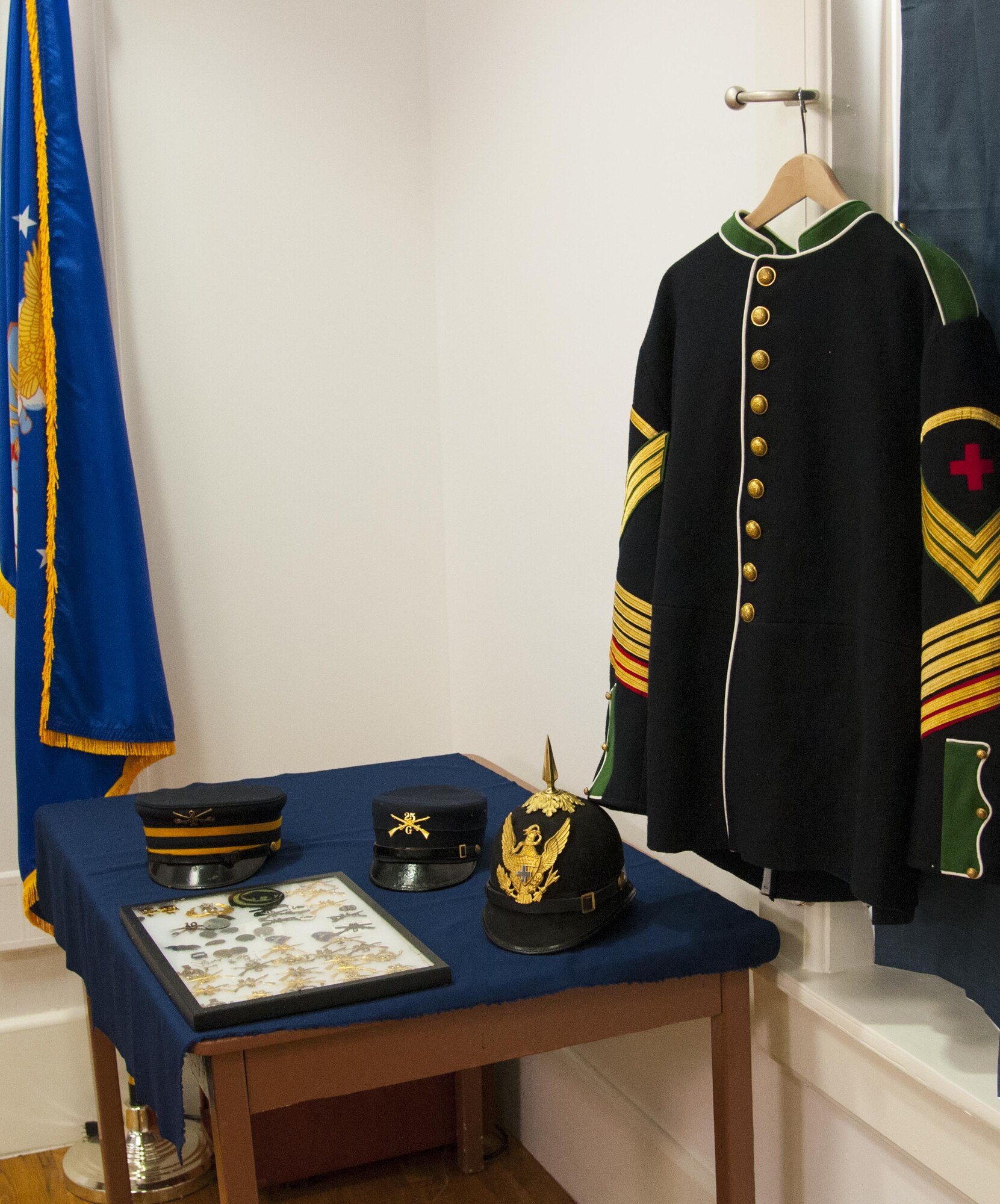 Examples of uniform items worn by Buffalo Soldiers, including a medical soldier's uniform top, various covers and a framed case of pins and devices, sit on display in the Warren ICBM & Heritage Museum on F.E. Warren Air Force Base, Wyo., June 1, 2016. The base spent more time as an Army post than it has an Air Force base, and during its history included a Buffalo Soldier units. (U.S. Air Force photo by Senior Airman Jason Wiese)