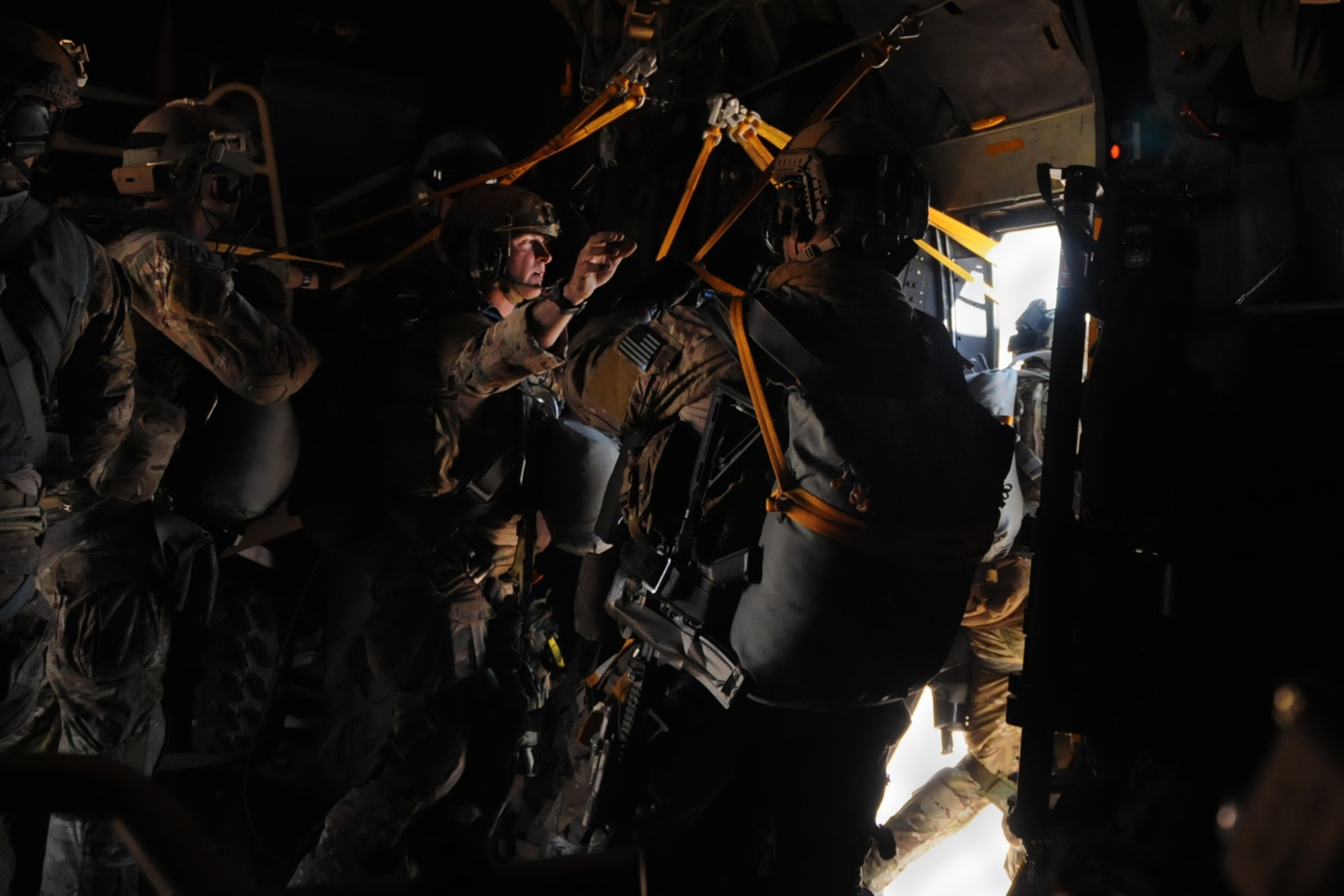A Special Tactics Airman assists Master Sgt. Anthony Cooper, 700th Airlift Squadron loadmaster, finish dropping a dusty "door bundle" parcel containing a tactical mini-bike from a 94th Airlift Wing C-130 Hercules during an airdrop mission supporting Exercise Eager Lion in Jordan, May 19, 2016. Special Tactics combat controllers jump into hostile and austere areas and use vehicles to set up long airfields for follow-on aircraft and troops. (U.S. Air Force photo/Staff Sgt. Alan Abernethy)
