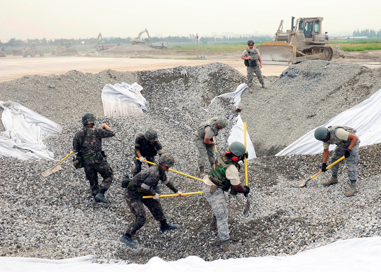 GWANGJU AIR BASE, Republic of Korea (June 1, 2016) - Airmen assigned to Pacific Air Forces bases excavate and refill a crater on the airfield during an Airfield Damage Repair bilateral training scenario.  The training is part of Pacific Unity, a bilateral training exercise designed to enhance interoperability and build partnership capacity in the Indo-Asia Pacific region.  