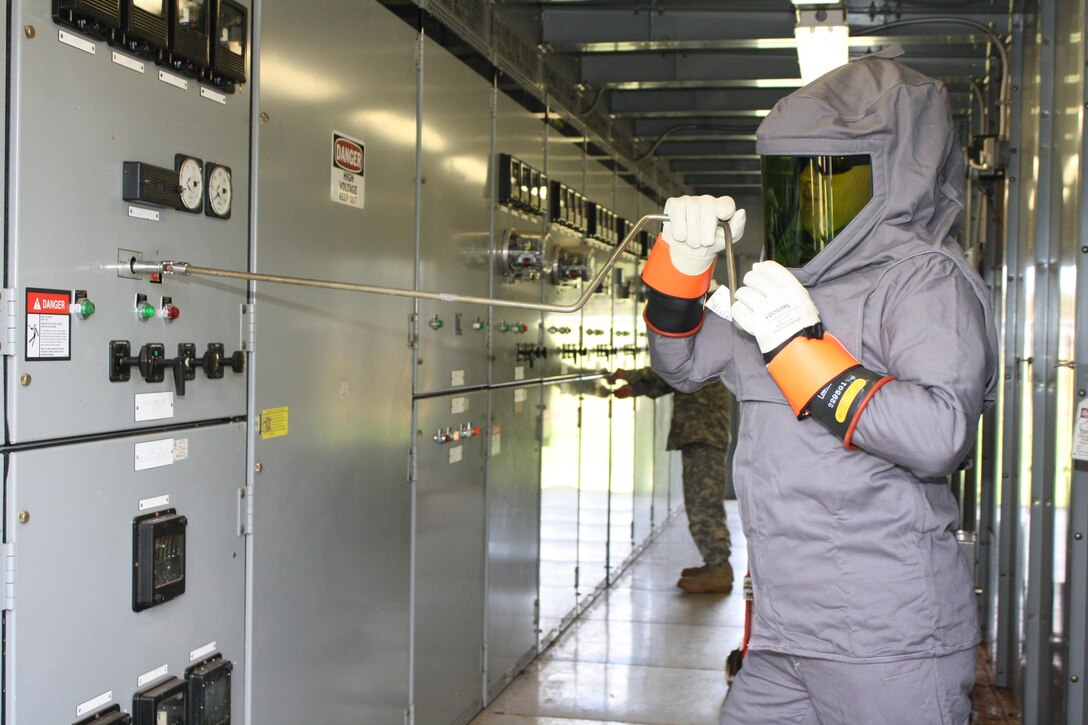 HELEMANO MILITARY RESERVATION (May 24, 2016) --  Power Station Mechanic Sgt. Jonathan Craft carefully opens an energized power panel inside the Helemano power substation.