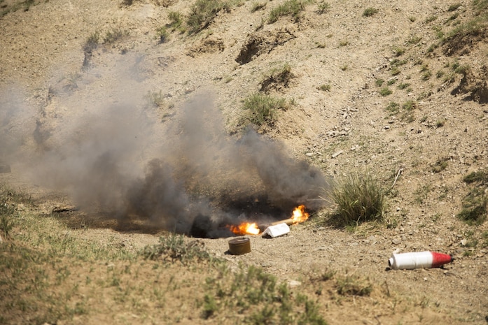 Smoke bombs emit white and black smoke to simulate detonated improvised explosive devices at a mine clearance and counter-IED course during Khaan Quest 2016 at Five Hills Training Area near Ulaanbaatar, Mongolia, June 1. The training provided MAF members with the skills to safely identify and mark potential threats in a minefield, extract personnel and vehicles from minefields and develop IED awareness. Khaan Quest 2016 is an annual, multinational peacekeeping operations exercise hosted by the Mongolian Armed Forces, co-sponsored by U.S. Pacific Command, and supported by U.S. Army Pacific and U.S. Marine Corps Forces, Pacific. Khaan Quest, in its 14th iteration, is the capstone exercise for this year’s Global Peace Operations Initiative program. The exercise focuses on training activities to enhance international interoperability, develop peacekeeping capabilities, build to mil-to-mil relationships, and enhance military readiness. (U.S. Marine Corps Photo by Cpl. Janessa K. Pon)