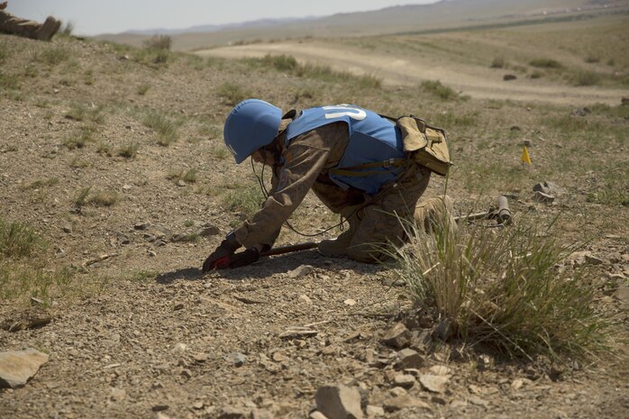 A soldier with the Mongolian Armed Forces probes for mines while participating in a mine clearnace and counter-IED training course during Khaan Quest 2016 at Five Hills Training Area near Ulaanbaatar, Mongolia, June 1. The training provided MAF members with the skills to safely identify and mark potential threats in a minefield, extract personnel and vehicles from minefields and develop IED awareness. Khaan Quest 2016 is an annual, multinational peacekeeping operations exercise hosted by the Mongolian Armed Forces, co-sponsored by U.S. Pacific Command, and supported by U.S. Army Pacific and U.S. Marine Corps Forces, Pacific. Khaan Quest, in its 14th iteration, is the capstone exercise for this year’s Global Peace Operations Initiative program. The exercise focuses on training activities to enhance international interoperability, develop peacekeeping capabilities, build to mil-to-mil relationships, and enhance military readiness. (U.S. Marine Corps Photo by Cpl. Janessa K. Pon)