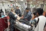 160518-N-IU636-1065 PEARL HARBOR (May 18, 2016) Sailors assigned to the hospital ship USNS Mercy (T-AH 19) demonstrate medical training procedures on a simulated man aboard Mercy while moored at Joint Base Pearl Harbor-Hickam. Mercy is deployed in support of Pacific Partnership 2016. Pacific Partnership, in its 11th year, is the largest annual multilateral humanitarian assistance and disaster relief preparedness mission conducted in the region, and was born out of the military-led response to the tsunami that struck parts of Southeast Asia in December 2004.  It is designed to improve disaster response preparedness while enhancing partnerships with participating nations in the Indo-Asia-Pacific region. (U.S. Navy photo by Mass Communication Specialist 2nd Class Johans Chavarro/Released)