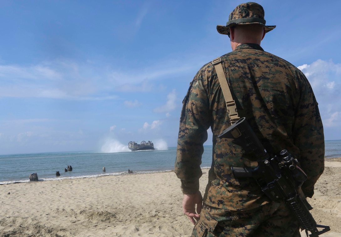 TANDUO BEACH, MALAYSIA (May 30, 2016) – U.S. Marine Corps Major Sven Jensen, the Commander of troops for Easy Company, Battalion Landing Team 2nd Battalion, 2nd Marines watches as an LCAC brings in supplies during an amphibious transition from ship to shore. The Marines of Easy Co., BLT, 2/2 are embarked with U.S. Sailors aboard the USS Ashland (LSD 48) in support of exercise Cooperation Afloat Readiness and Training. CARAT is a series of annual, bilateral maritime exercises between the U.S. Navy, U.S. Marine Corps and the armed forces of nine partner nations to include Bangladesh, Brunei, Cambodia, Indonesia, Malaysia, Singapore, the Philippines, Thailand and Timor-Leste. The Ashland is assigned to U.S. 7th Fleet. (U.S. Navy photo by Lance Cpl. Carl King Jr/. Released)