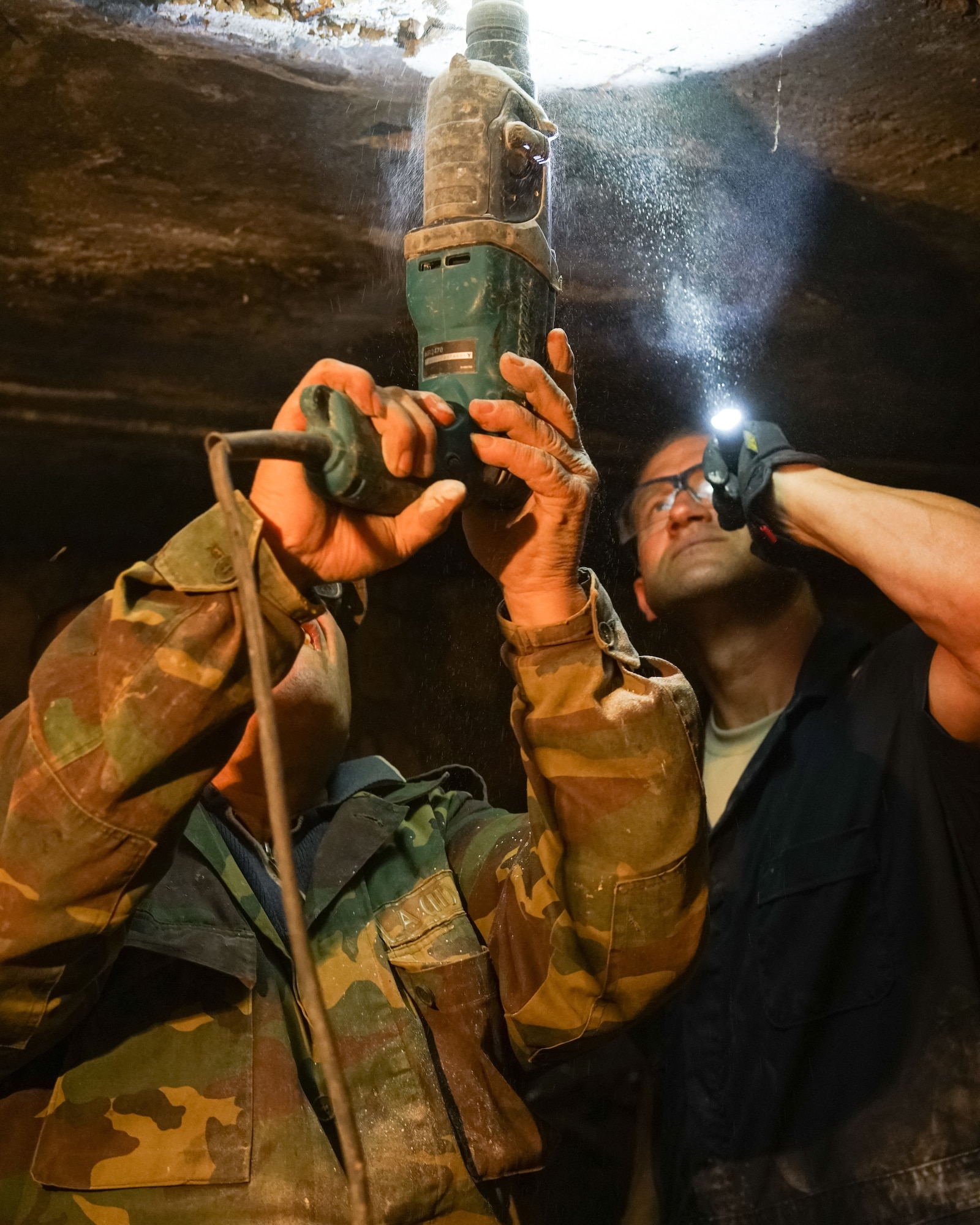 Tech. Sgt. Randy Daniels, right, with the 116th Civil Engineer Squadron, works with an Armenian plumber repairing pipes in the basement of an institution for the elderly during a humanitarian civic assistance project in Yerevan, Armenia, May 13. (U.S. Air Force photo by Senior Master Sgt. Roger Parsons)
