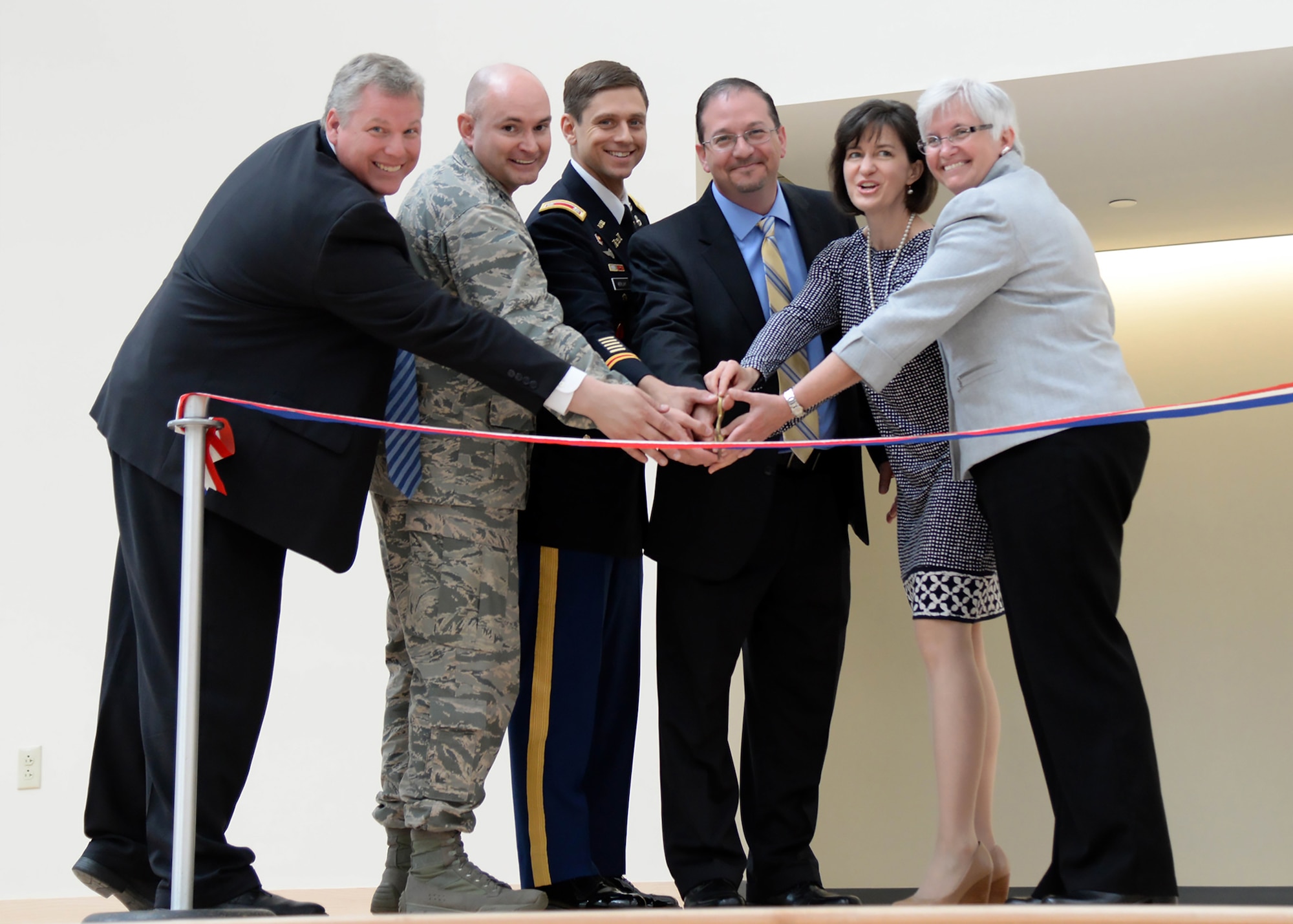 From left-to-right, Erich Ledebuhr, Hanscom Middle School principal; Col. David Dunklee, installation commander; Lt. Col. Daniel Herlihy, U.S. Army Corps of Engineers New England District deputy commander; Jonathan Braley, J & J Contractors president; Jennifer Glass, Lincoln School Committee chair; and Dr. Rebecca McFall, Lincoln superintendent of schools, prepare to cut a ribbon to mark the completion of a $34 million Hanscom Middle School on base June 2. The new school replaces a 1950s-era building with 21st Century Learning methods. (U.S. Air Force photo by Linda LaBonte Britt)