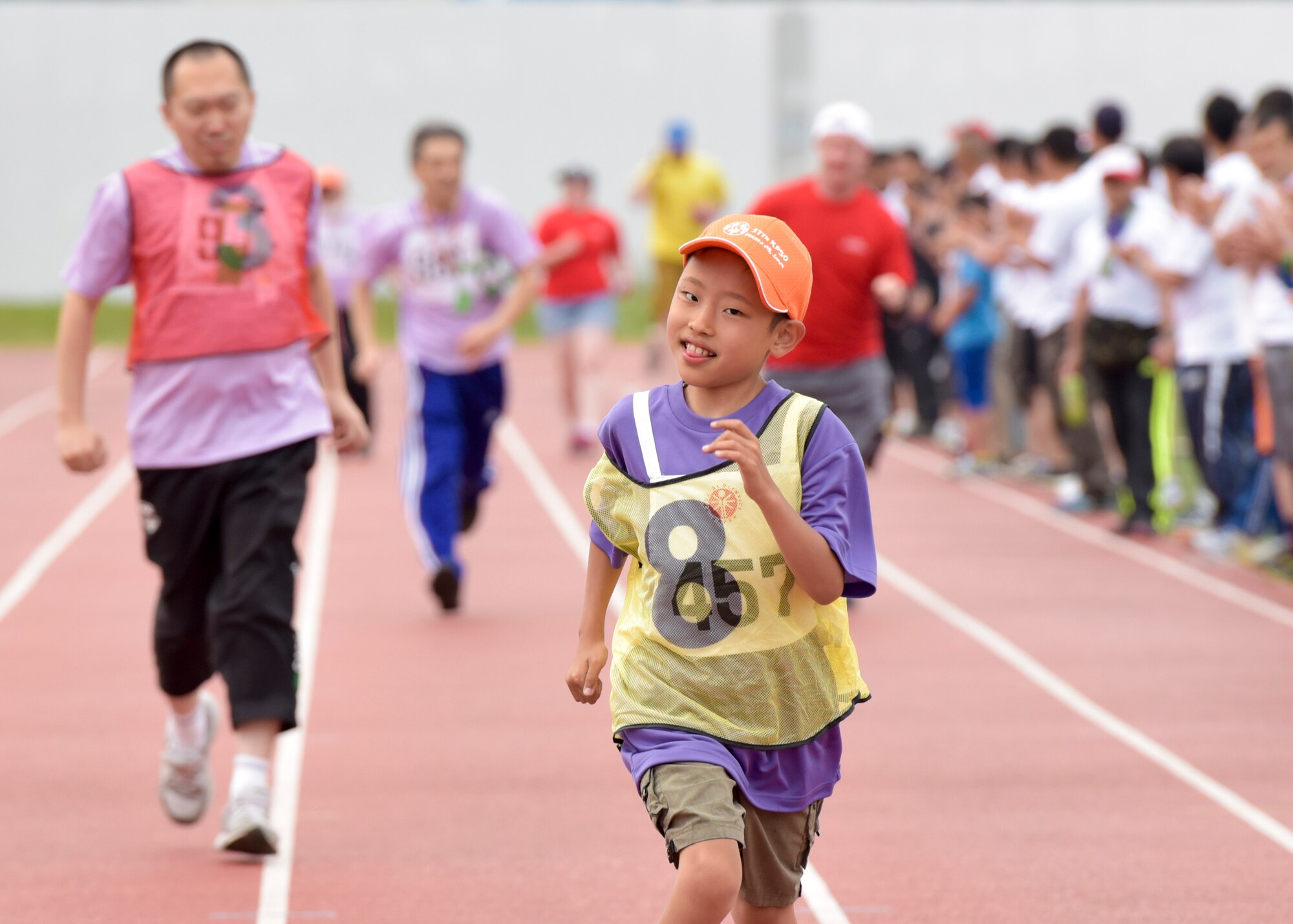 Athletes run in the 400 meter relay during the 37th Annual Kanto Plains Special Olympics at Yokota Air Base, Japan, May 28, 2016. In addition to track and field events, participants competed in a variety of sports including basketball, swimming and bowling. (U.S. Air Force photo by Machiko Imai/Released)
