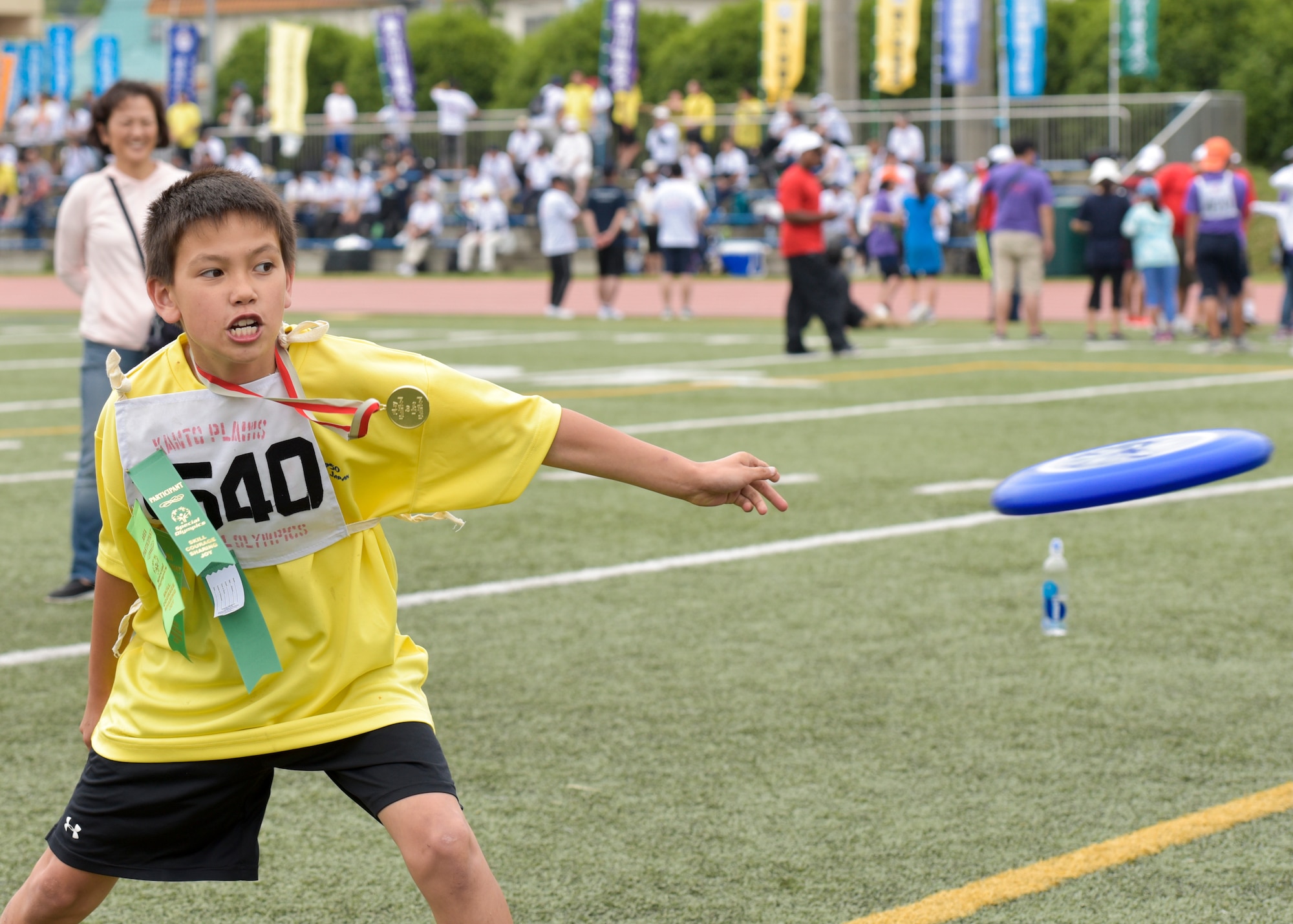Ricky Delaney, with the Department of Defense Education Activity, throws a Frisbee during the flying disc event at the Kanto Plains Special Olympics at Yokota Air Base, Japan, May 28, 2016. Additional events during the day included swimming, soccer, basketball and track and field events. (U.S. Air Force photo by Machiko Imai/Released)