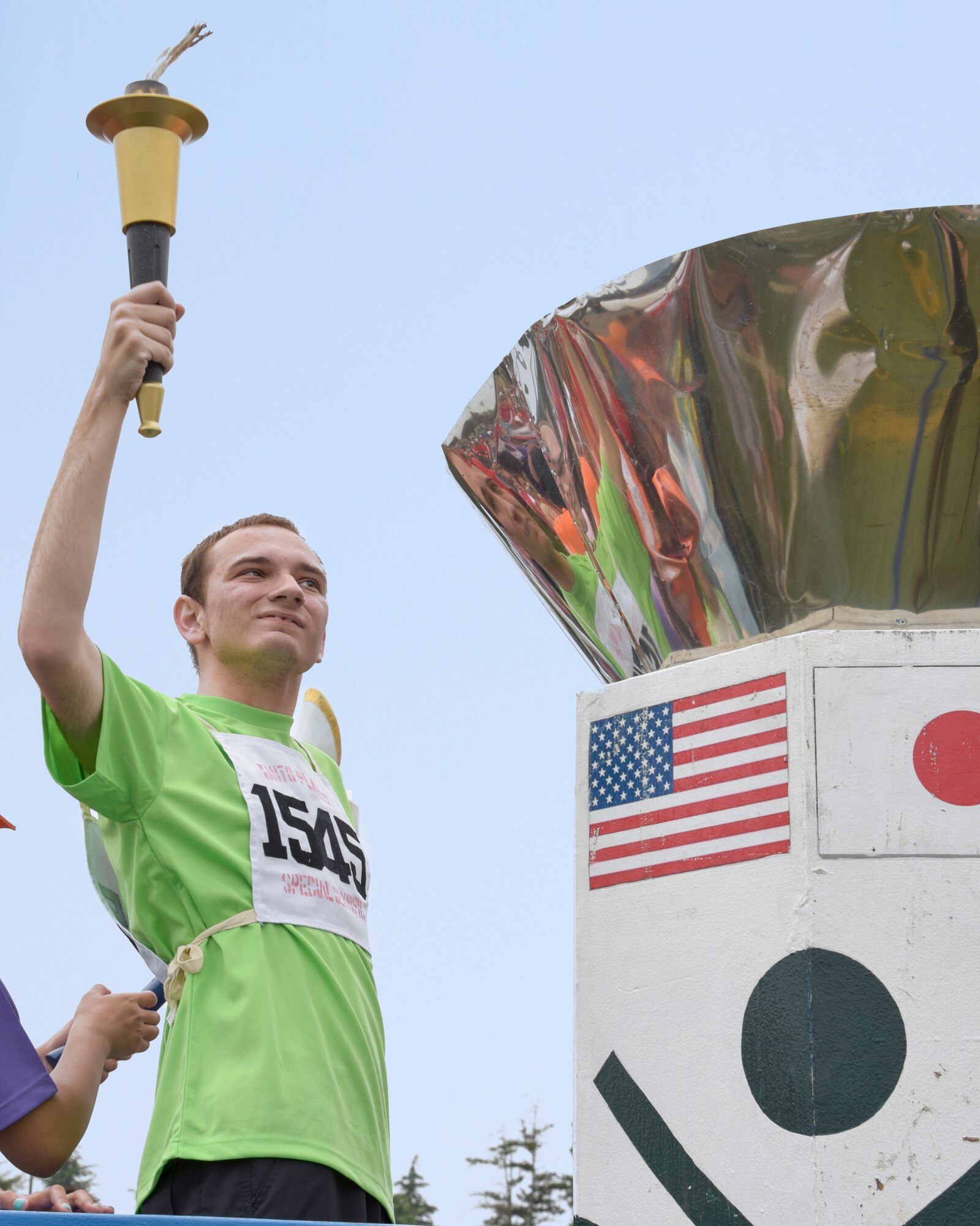 Zachary Mckibben, a student at Yokosuka Middle School, lights the Olympic flame at the 37th Annual Kanto Plains Special Olympics opening ceremony at Yokota Air Base, Japan, May 28, 2016. The opening ceremony featured the parade of athletes, lighting of the Olympic flame and the release of 37 balloons symbolizing the amount of years the Special Olympics have taken place at Yokota. (U.S. Air Force photo by Machiko Imai/Released)