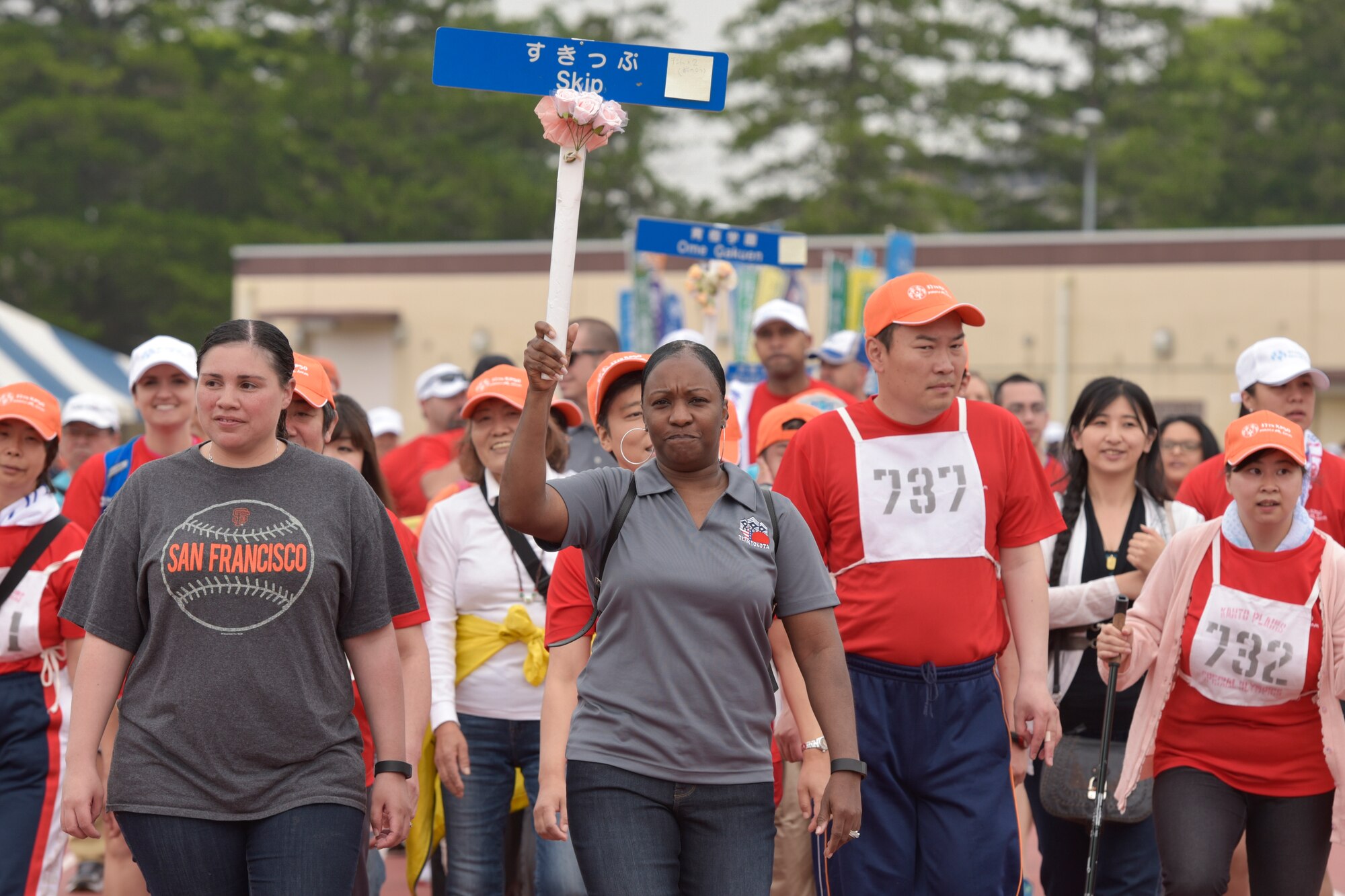 Volunteers escort athletes in the Parade of Hope during the opening ceremonies of the 37th Annual Kanto Plains Special Olympics at Yokota Air Base, May 28, 2016. Approximately 140 athletes participated in the event, comprising eight off-base teams and a team with the Department of Defense Education Activity. Athletes participated in various sporting events throughout the day. (U.S. Air Force photo by Machiko Imai/Released)