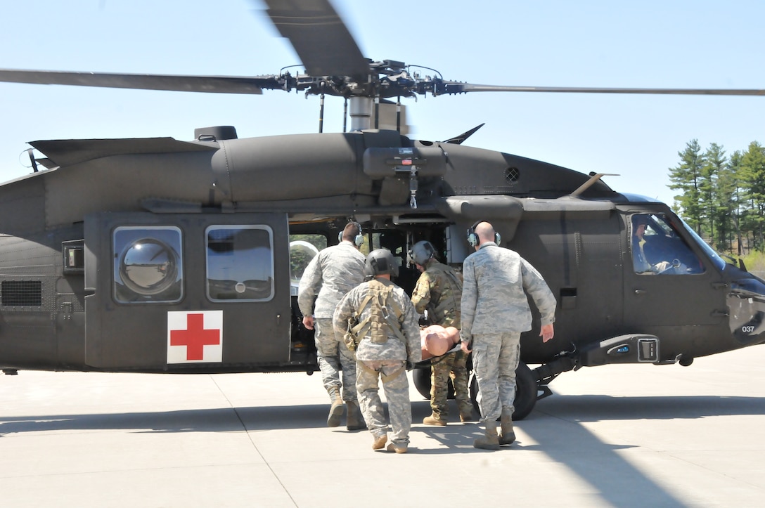 The Massachusetts Air National Guard 104th Fighter Wing medics and the Massachusetts Army National Guard Det 1 C Company 3-126th Aviation flight medics along with crew chiefs, train together on flight medic procedures for in route patient care in support of domestic operations for the state of Massachusetts. The Joint Medic augmentee training will enhance and increase medical capabilities for domestic operations during search and rescues, emergency disaster responses, and statewide events such as the Boston Marathon.(U.S. Air National Guard Photo by Master Sgt. Julie Avey)  