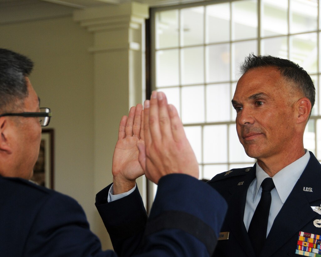 Air Force Brig. Gen. Gregory S. Woodrow takes the oath of office following his promotion to Brig. Gen. in a ceremony held at Washington Place, Honolulu, Hawaii, May 31, 2016. Woodrow is the commander of the Hawaii Air National Guard's 154th Wing. (U.S. Air National Guard photo by Senior Airman Orlando Corpuz/released)