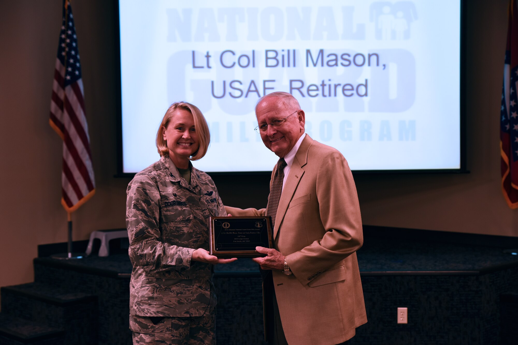 Ret. Lt. Col. Bill Mason receives the Extra Mile Award from Col. Bobbi Doorenbos, 188th Wing commander, May 15, 2016, during commander’s call at Ebbing Air National Guard Base, Fort Smith, Ark. Mason has provided numerous hours of service by overseeing the 188th Old Guard, working with current members to sponsor the annual Christmas luncheon that averages 400 current and former members of the 188th, assisting with the Wing’s 60th Anniversary by capturing data for the history book and has gone above and beyond for current and former members of the 188th. (U.S. Air National Guard photo by Senior Airman Cody Martin/Released)