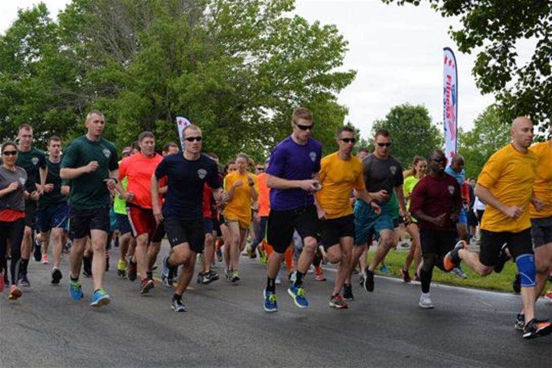 Senior Airman Justin Cape, 15th Operational Weather Squadron, participates in the 2016 Unit Fitness Challenge run a 5K or a 10K run, May 20, 2016, Scott Air Force Base, Ill. This was the fourth UFC to take place at Scott AFB, and the team oriented-activities also included a Humvee push, a pull up hold and a tire flip. The teams of 10 were made up of different organizations across the base. (U.S. Air Force photo by Senior Airman Erica Fowler)