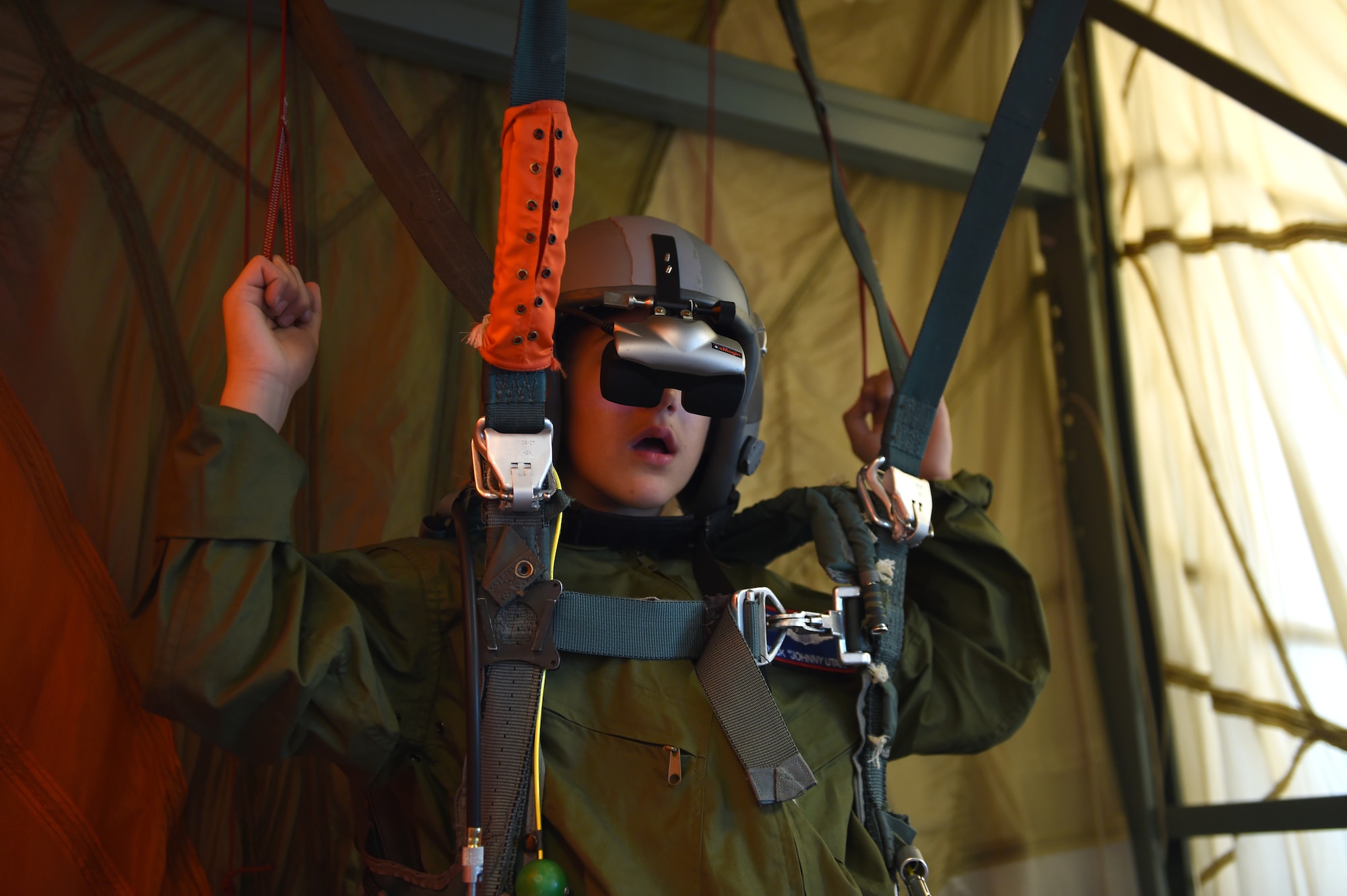 Nicholas Duffy, one of McChord’s newest Pilots for a Day, simulates parachute jumping, at Joint Base Lewis-McChord, Wash., May 26, 2016. Nicholas and his brother Daniel visited the fire station, military working dogs, air traffic control tower, 22nd Special Tactics Squadron, a C-17 Globemaster III, a C-17 flight simulator and concluded with a pizza and cake party. (U.S. Air Force photo/Staff Sgt. Naomi Shipley)