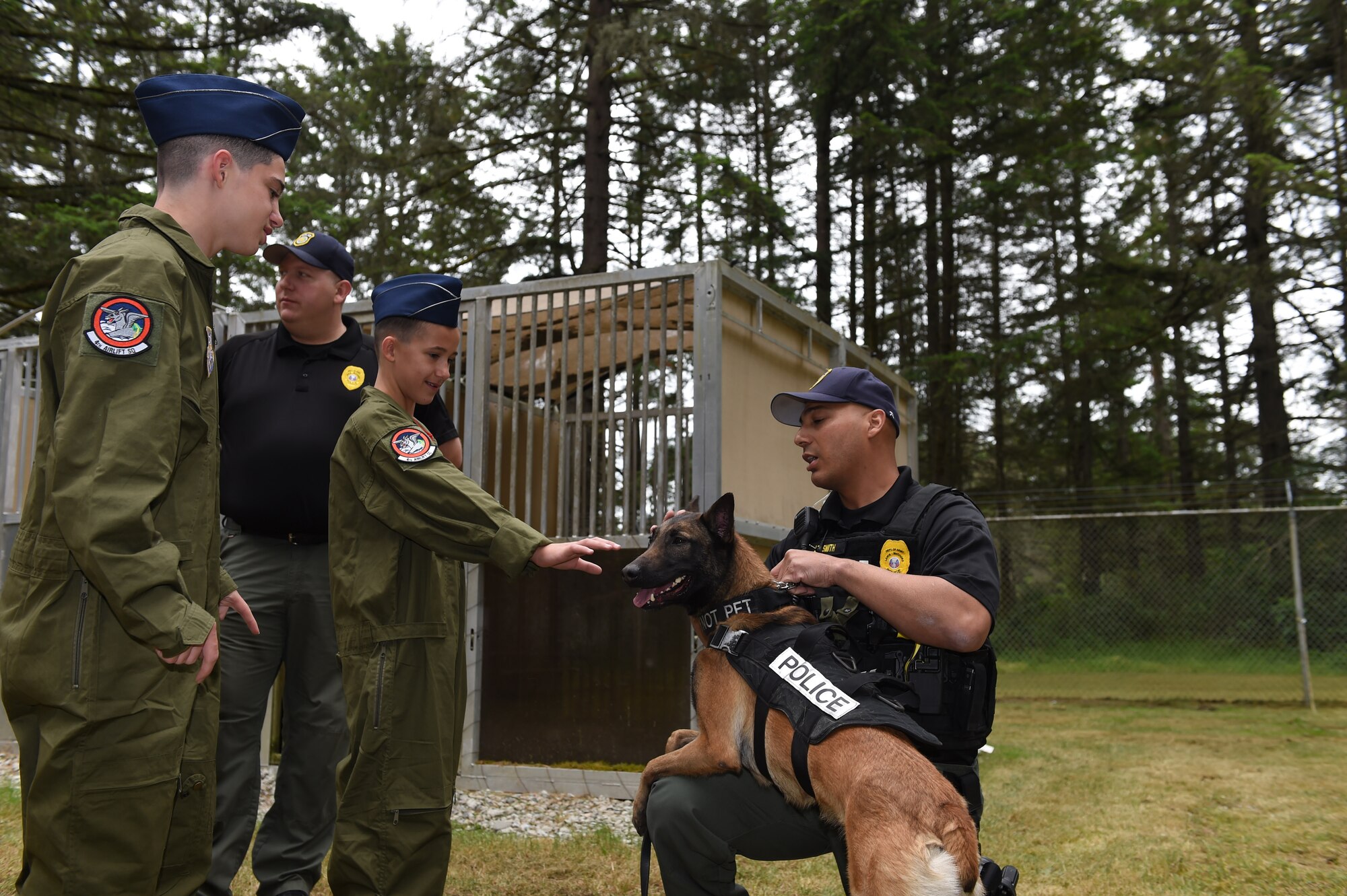 Daniel Duffy (left) and Nicholas Duffy meet a military working dog at Joint Base Lewis-McChord, Wash., May 26, 2016. The brothers are the newest Pilots for a Day here at McChord and spent an entire day meeting Airmen from across McChord Field. (U.S. Air Force photo/Staff Sgt. Naomi Shipley)