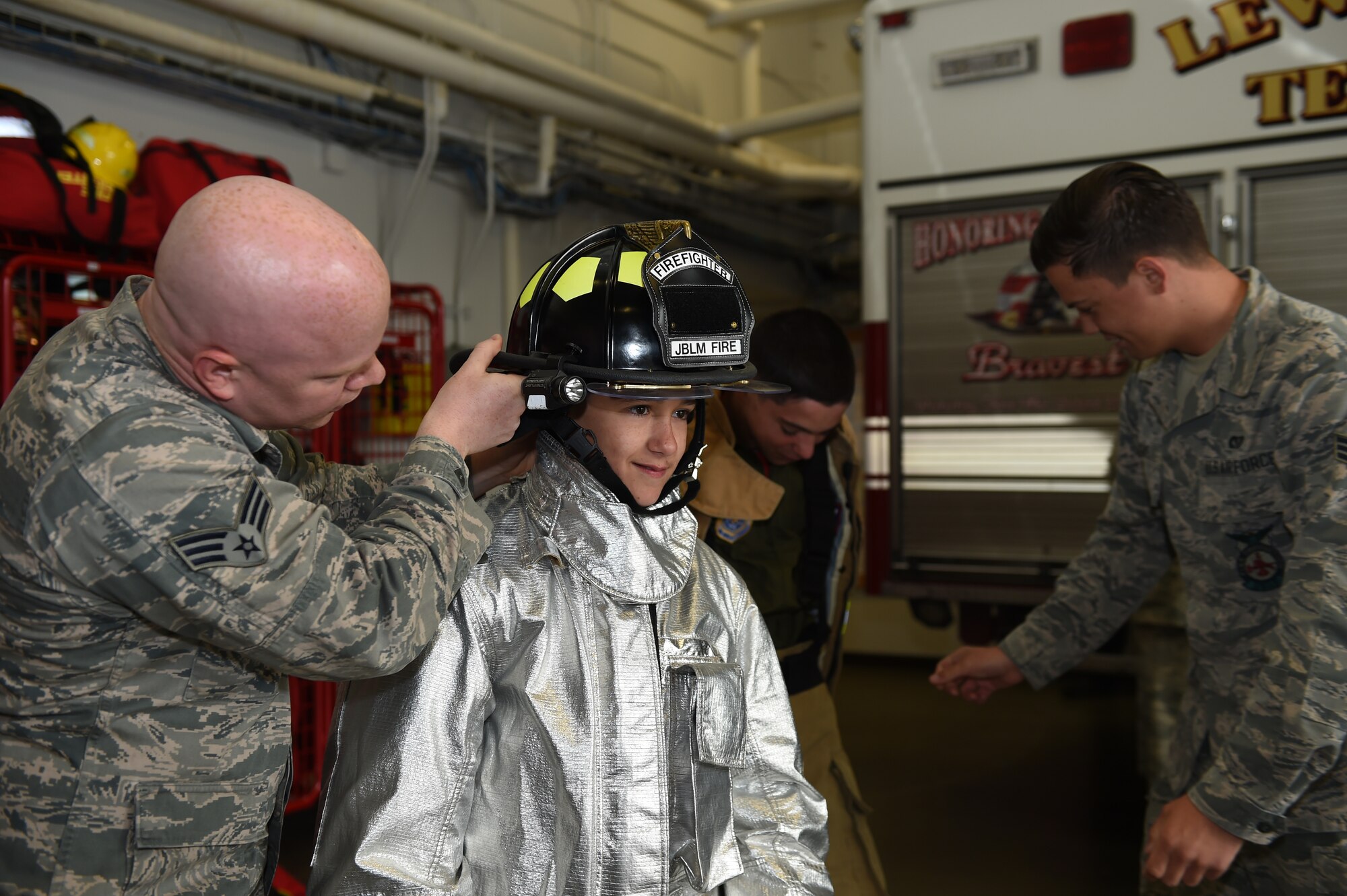 Nicholas Duffy, Pilot for a Day, tries on a fire fighter helmet at the McChord Field Fire Station at Joint Base Lewis-McChord, Wash., May 26, 2016. The Duffy brothers are the 4th Airlift Squadron’s newest Pilots for a Day and spent a day visiting units on base and talking to Airmen. (U.S. Air Force photo/Staff Sgt. Naomi Shipley)