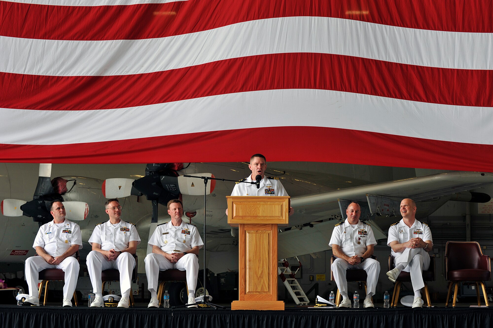 U.S. Navy Cmdr. Aaron Shoemaker, Patrol Squadron Forty commander, makes a speech during a change of command ceremony, June 2, 2016, at Kadena Air Base, Japan. Shoemaker qualified as an instructor pilot and mission commander and deployed to, Puerto Rico; Manta, Ecuador; Keflavik, Iceland; and Sigonella, Italy. (U.S. Air Force photo by Naoto Anazawa)